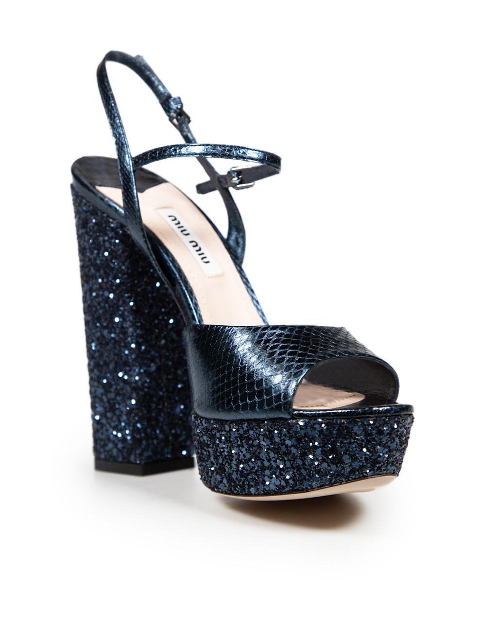 CONDITION is Very good. Minimal wear to the sandals is evident. Abrasion on both in soles, the right ankle strap and left toe strap on this used Miu Miu designer resale item.

Details


Blue

Leather

Sandals

Snakeskin pattern

Glitter