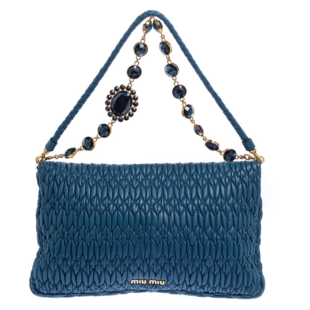 This gorgeous bag by Miu Miu will carry your essentials with ease. Brilliantly designed, this blue bag has a flap design and a chain with crystals. Flaunt this pretty-looking Matelasse leather bag for a sophisticated look.

Includes: Original