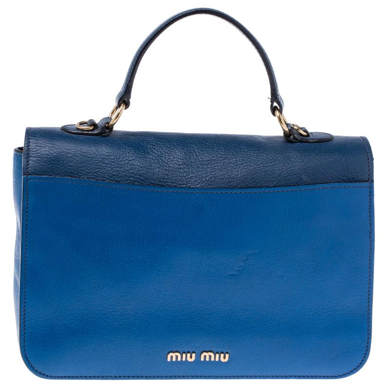 Stunning to look at and durable enough to accompany you wherever you go, this Miu Miu bag is a joy to own! This Madras bag is crafted from leather and held by a single handle and a shoulder strap. The insides are satin-lined and perfectly sized to