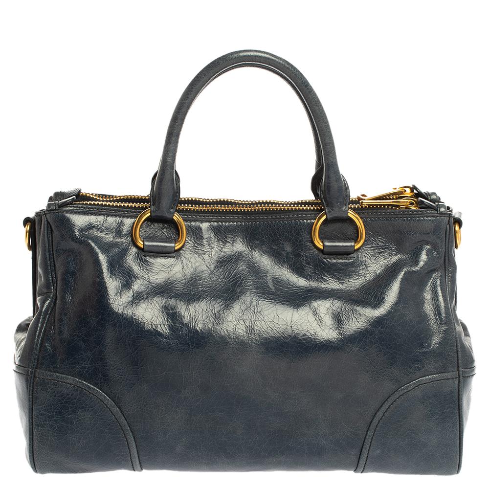 Classy and apt to profile a refined and well thought out look, this Miu Miu tote will never fail to impress onlookers. It is crafted from blue leather and styled with gold-tone hardware. It features the brand logo on the front and comes with