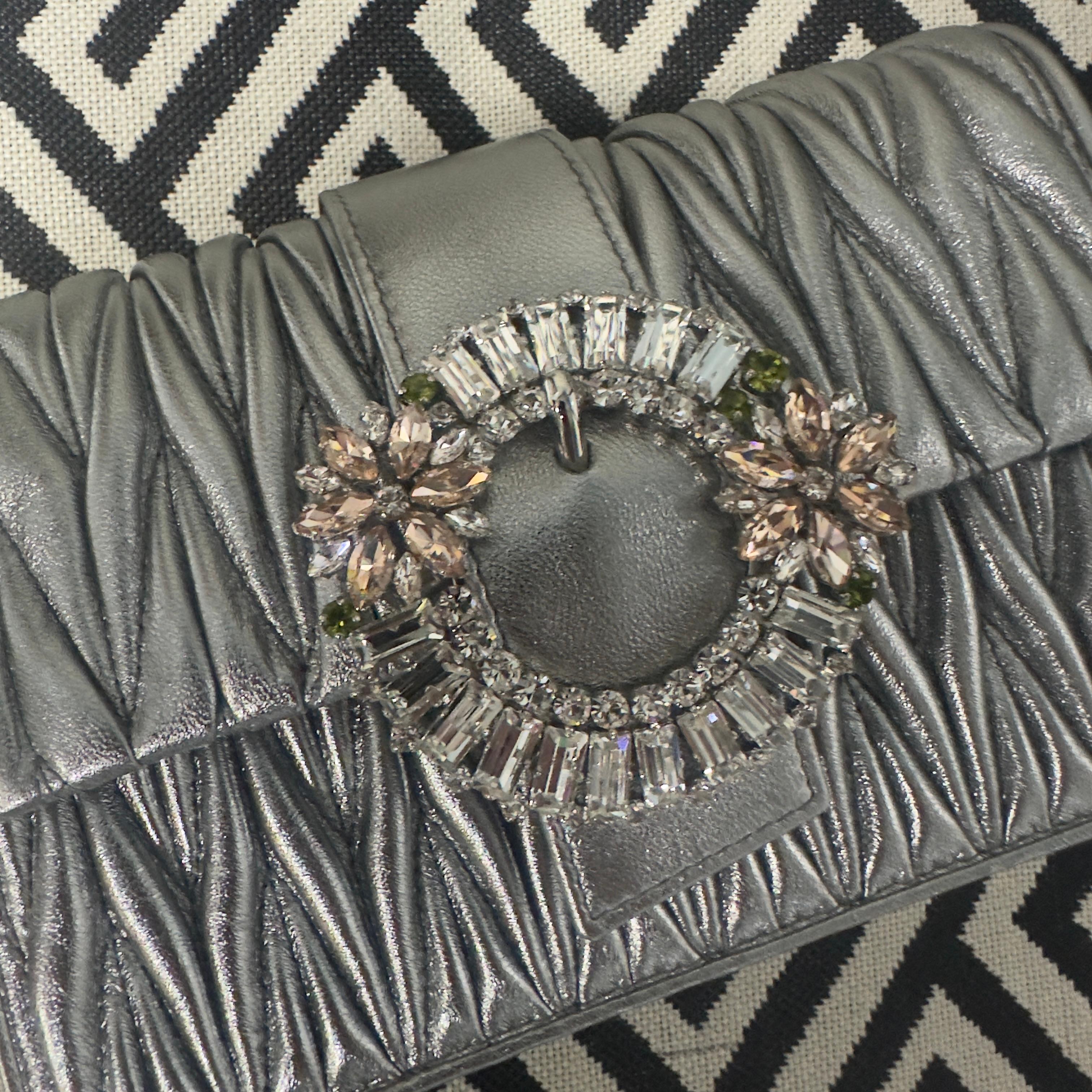Miu Miu bag in silver matelassé leather with jewel closure 
Equipped with chain  also silver-colored can be worn either over the shoulder or hand clutch bag 
New with box, dust and tags, still has protective film and cloth 
Measurements in cm 
12x