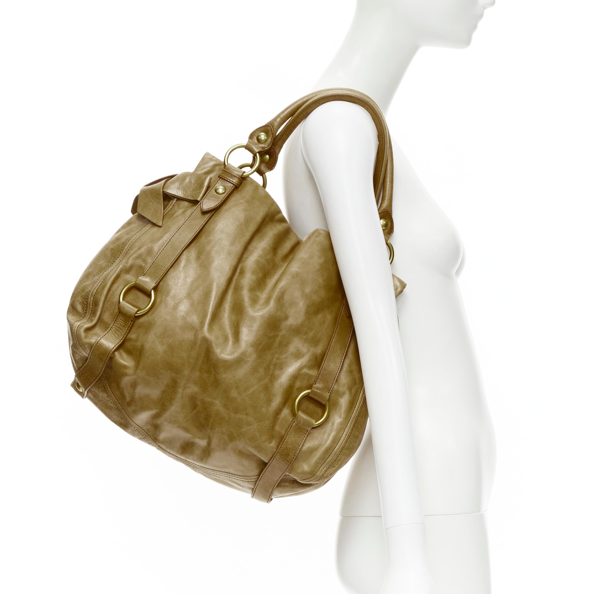 MIU MIU brown crinkled leather gold-tone strap bow detail hobo tote bag 
Reference: CELG/A00144 
Brand: Miu Miu 
Designer: Miuccia Prada 
Material: Leather 
Color: Brown 
Pattern: Solid 
Closure: Button 
Extra Detail: Tan crinkled leather. Gold-tone