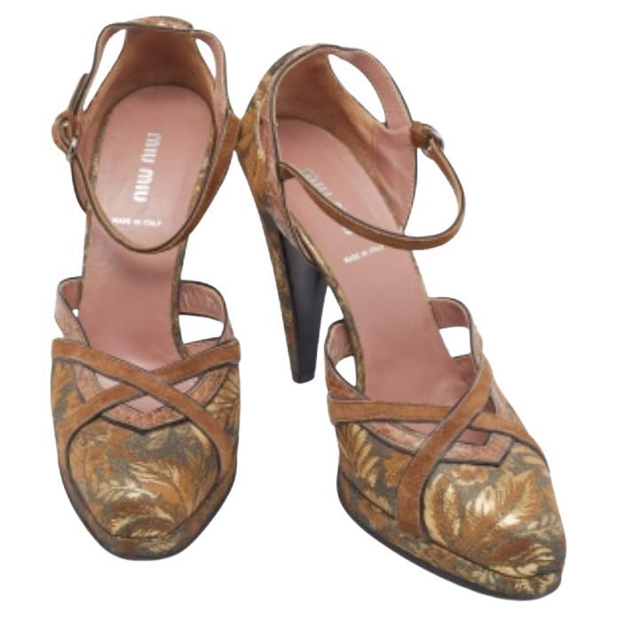 Dieses Paar hübscher Pumps aus dem Hause Miu Miu ist ein wahrer Tragegenuss. Peppen Sie Ihren Look mit diesen braun-goldenen Pumps aus Brokatstoff mit Pythonlederbesatz auf. Setzen Sie nur wenige Accessoires ein, damit sie die ganze Aufmerksamkeit
