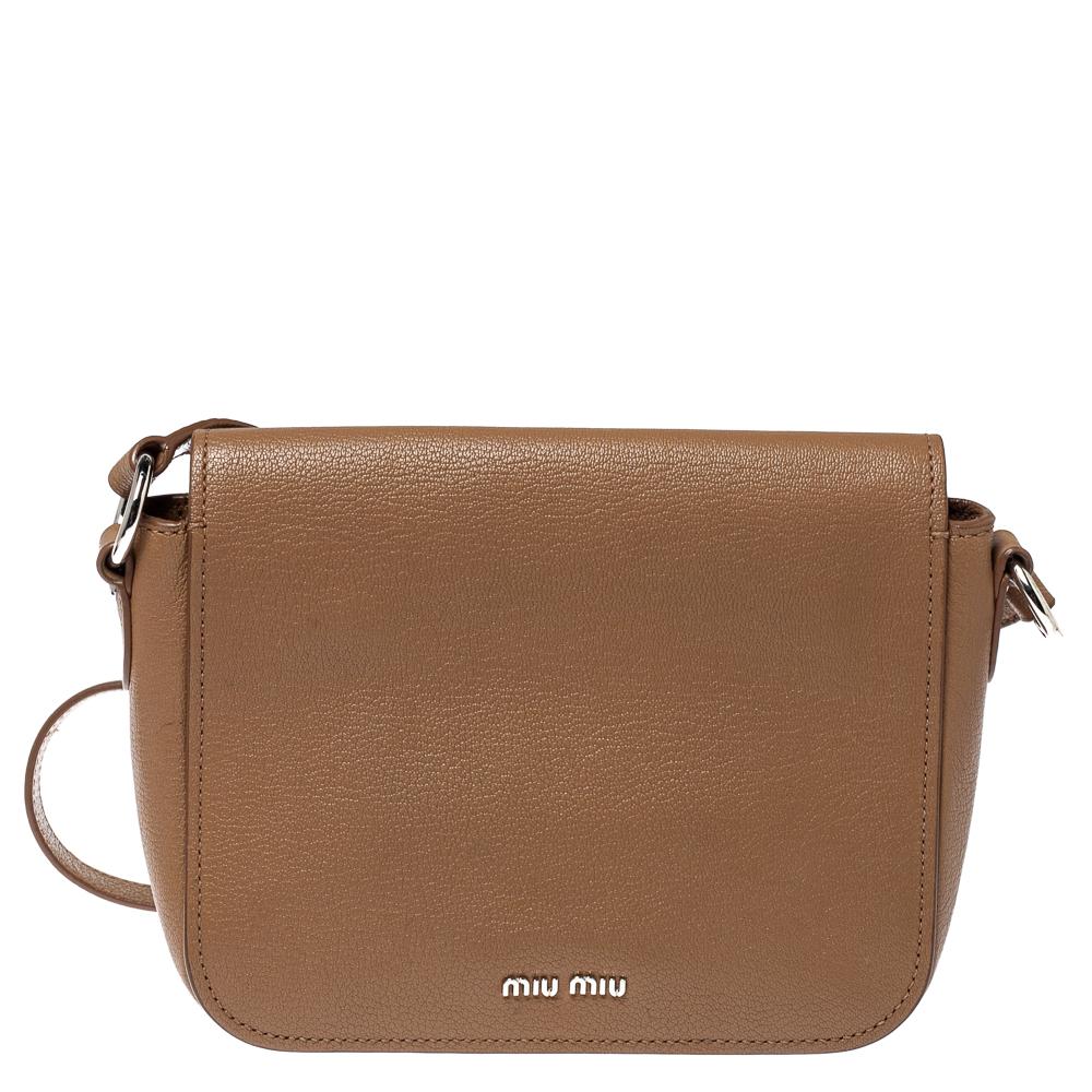 A comfortable bag to carry without compromising on style. Made from brown leather, the logo-detailed flap opens to a satin-lined interior. The Miu Miu bag is complete with a shoulder strap.

Includes: Info Booklet, Authenticity Card