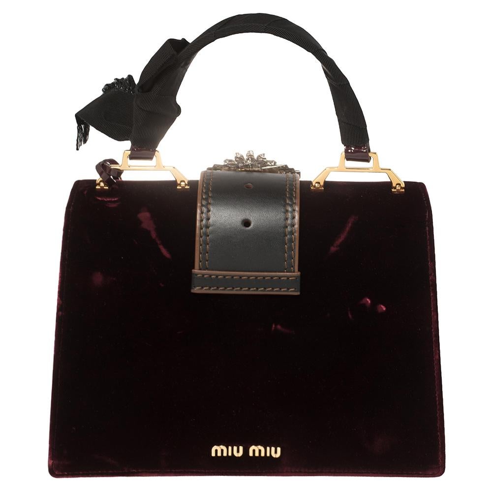 Flaunt classic fashion wherever you go with this Miu Miu bag. It is crafted from velvet and leather and the embellished lock on the flap leads to a spacious satin-lined interior with a zip pocket and enough space for your essentials. Held by a top