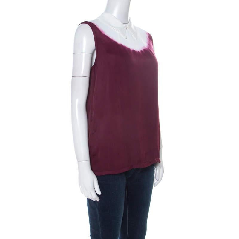 The tie-dye trend has dawned and we are onboard. You can join the wave with this sleeveless top from Miu Miu. It is made from cotton and it features a collar, buttons at the back and a mix of burgundy and white.