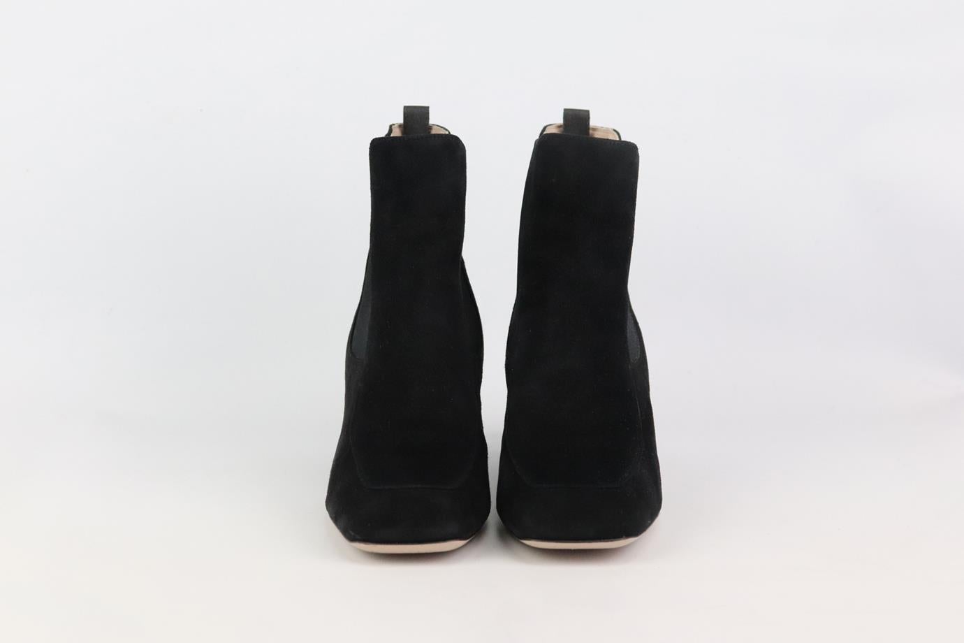 These slick ankle boots by Miu Miu are a must-have for fall, they are made from suede with a block heel embellished with signature gleaming crystals. Heel measures approximately 60 mm/ 2.4 inches. Black suede. Pull on. Does not come with box or