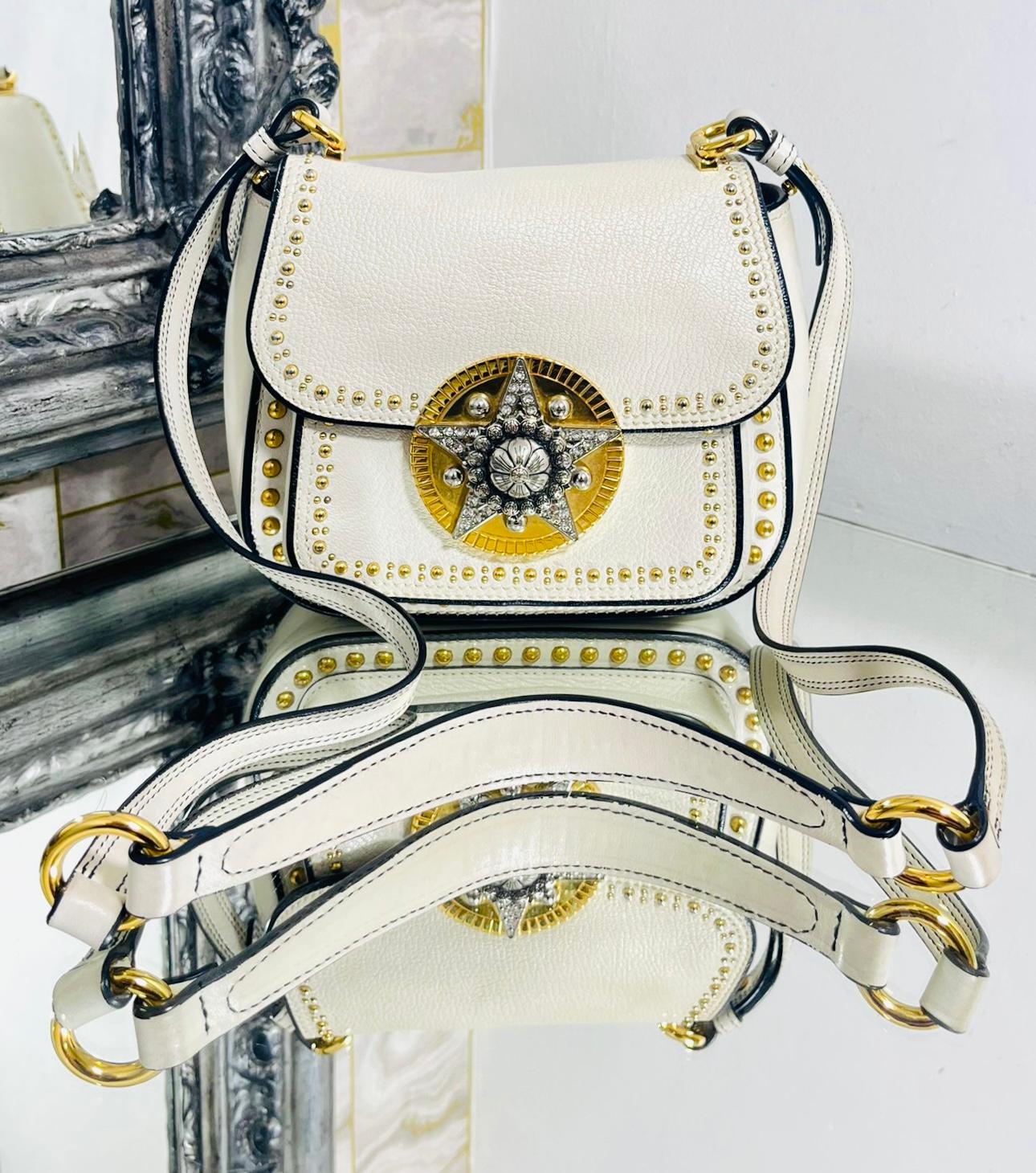 Miu Miu Dahlia Star Leather Crossbody Bag

White bag designed with gold, crystal lined star decoration to the centre and metal studs along the seams.

Featuring front, flap closure and gold 'Miu Miu' logo to rear.

Styled with long, shoulder strap,
