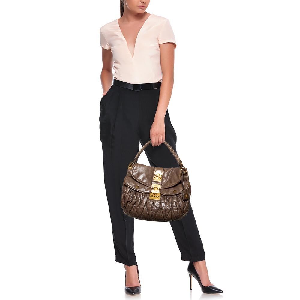 This chic and feminine Coffer hobo is from Miu Miu. The bag is crafted from leather carrying the signature matelassé pattern and features a flap that opens up to a fabric-lined interior sized to fit your daily essentials. The hobo is equipped with a