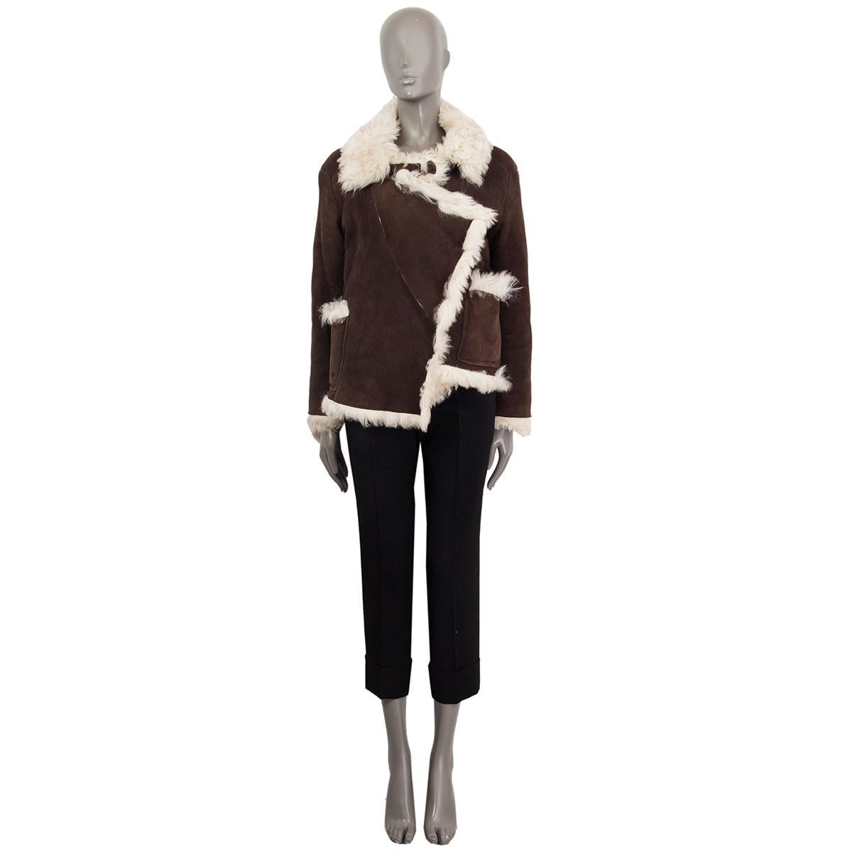 authentic Miu Miu jacket in brown suede and off-white sheep fur lining. With flat collar, chest flap, two welt pockets and two fur-trimmed patch pockets on the front. Opens with push-buttons. Has been worn and is in excellent condition. 

Tag Size