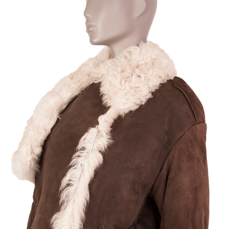 Miu Miu double-breasted coat in suede brown and off-white sheep fur lining. With flat collar, epaulettes, chest flap, two welt pockets, and two fur-trimmed patch pockets on the front. Has been worn and is in excellent condition. 

Tag