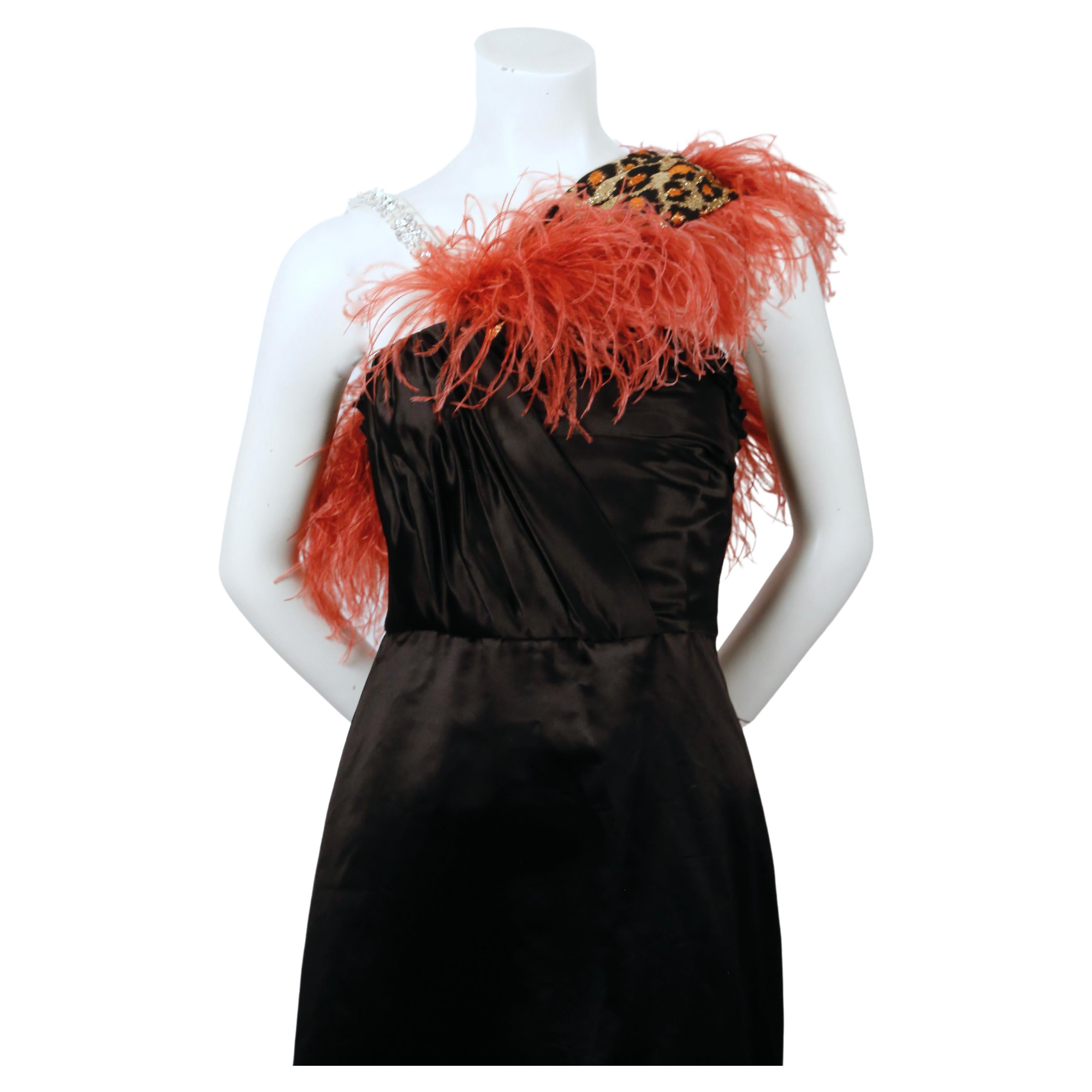 Very rare, black duchesse satin evening gown with ostrich feather trim, beaded strap and metallic leopard accent designed by Miu Miu as seen on the 2019 resort runway. Italian size 40. Approximate measurements: bust 32.5