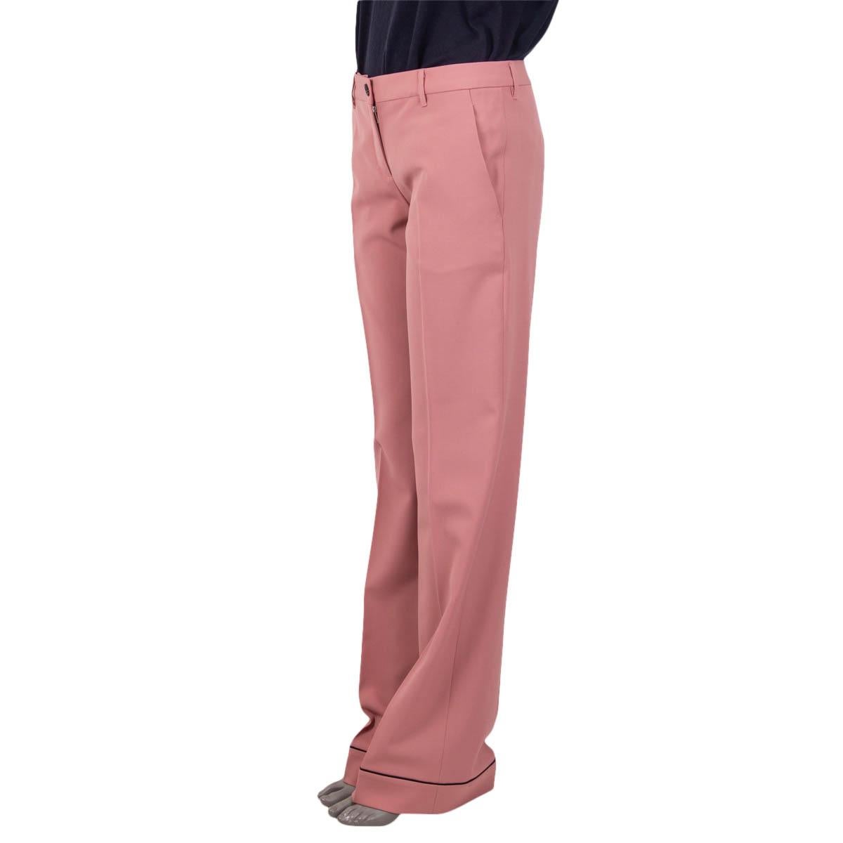 100% authentic Miu Miu wide-leg pants in pink and black virgin wool (98%) and elastane (2%). Feature two slit pockets on the front and one sewn shut slit pocket on the back. Have black piped cuffs and a mid-rise fit. Open with two buttons and a