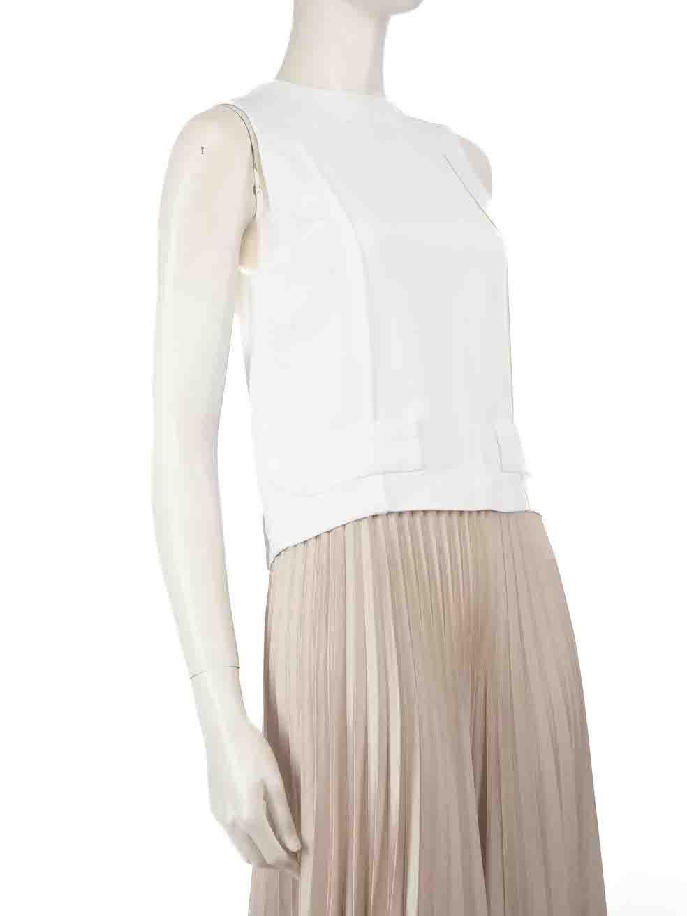 CONDITION is Very good. Minimal wear to vest is evident. Minimal discolouration to centre front and rear shoulder on this used Miu Miu designer resale item.
 
 
 
 Details
 
 
 Ecru
 
 Viscose
 
 Top
 
 Back button up fastening
 
 Sleeveless
 
 
 
