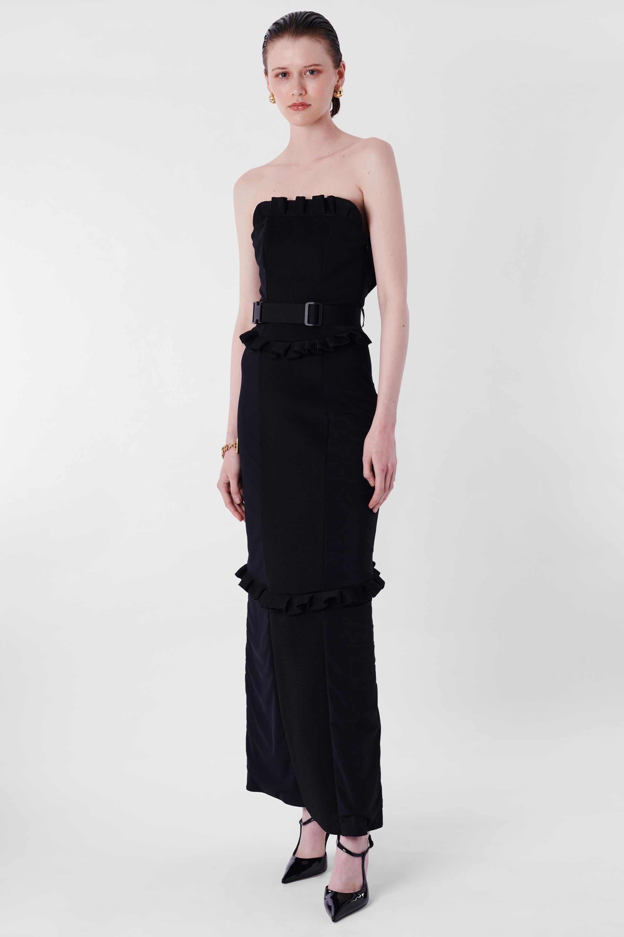 Miu Miu A/W 1999 Runway Black Ruffled Strapless Maxi Dress. Features strapless top with ruffles, contrast net fabric and neoprene, back pocket and buckle waist belt, open back with concealed side zipper and maxi length. In excellent vintage