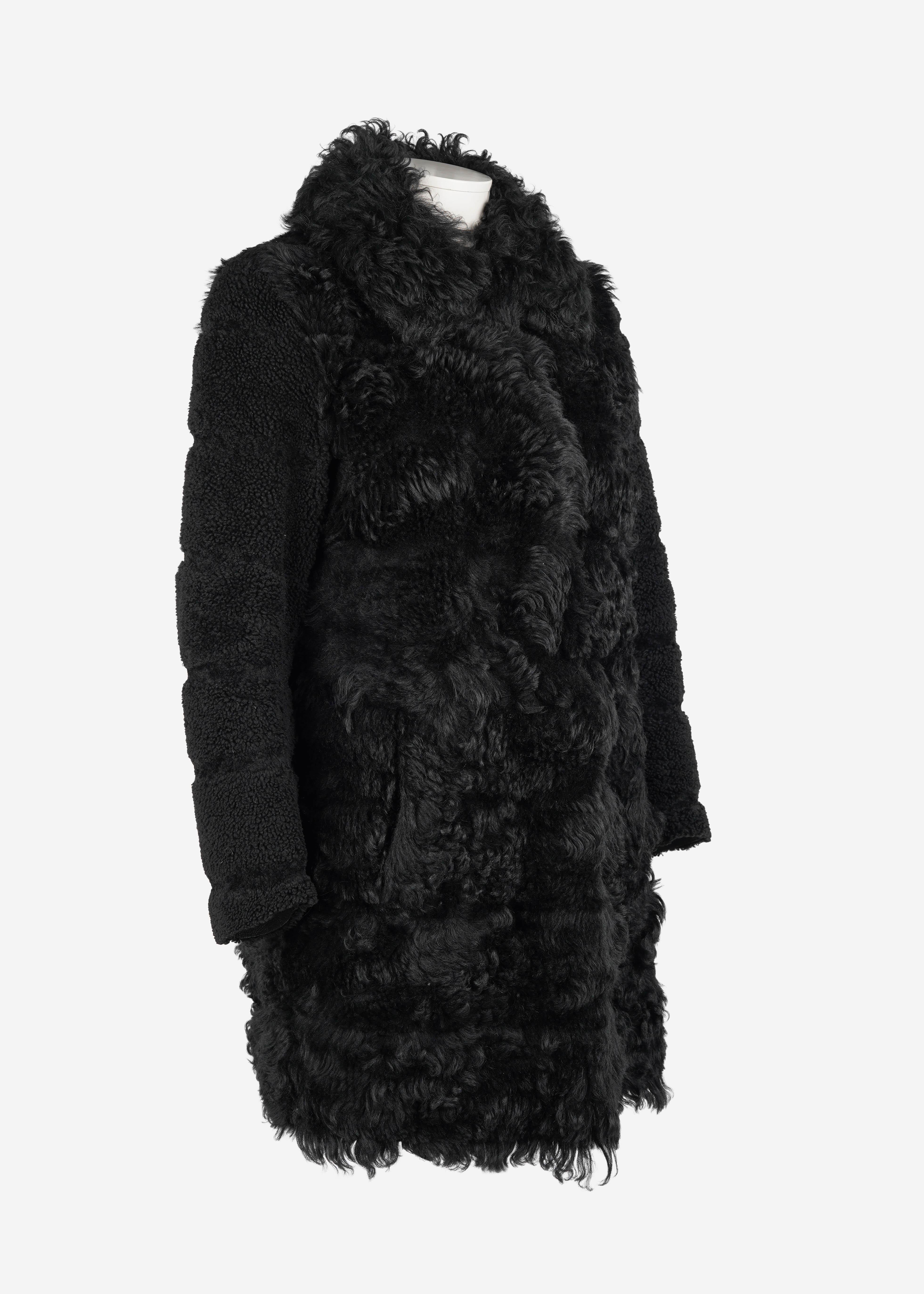 An exquisite piece from Miu Miu’s Fall/Winter 2012 collection, this luxurious coat is crafted from dyed Spanish shearling (Ovis Aries) and meticulously made in Italy. It reflects Miu Miu’s signature mix of sophistication and modern edge, featuring