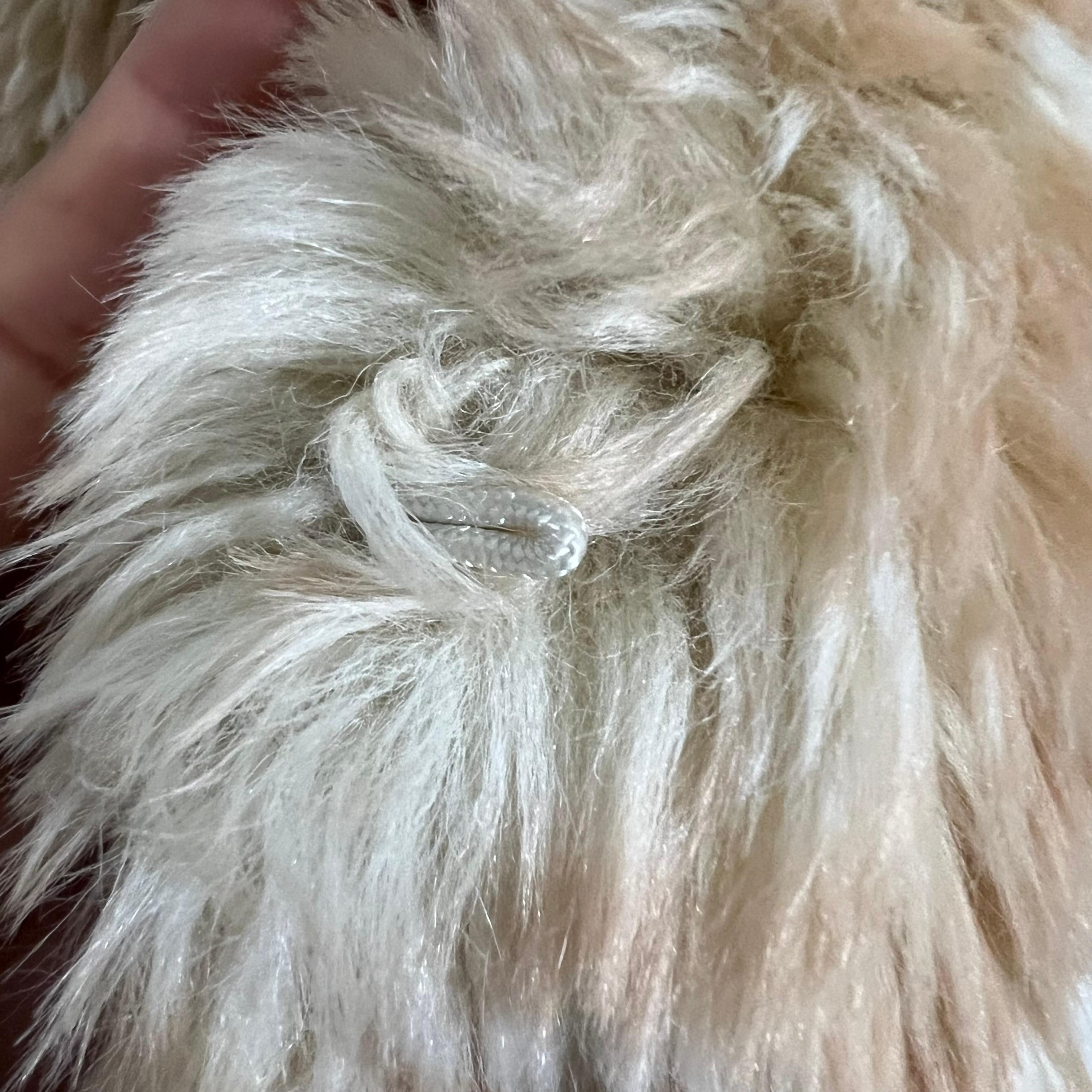 Make a bold statement with this Miu Miu faux deer fur coat, a playful yet luxurious piece that embodies the brand’s eclectic aesthetic. The plush faux fur mimics the natural texture and pattern of deer fur, creating a unique and eye-catching look.