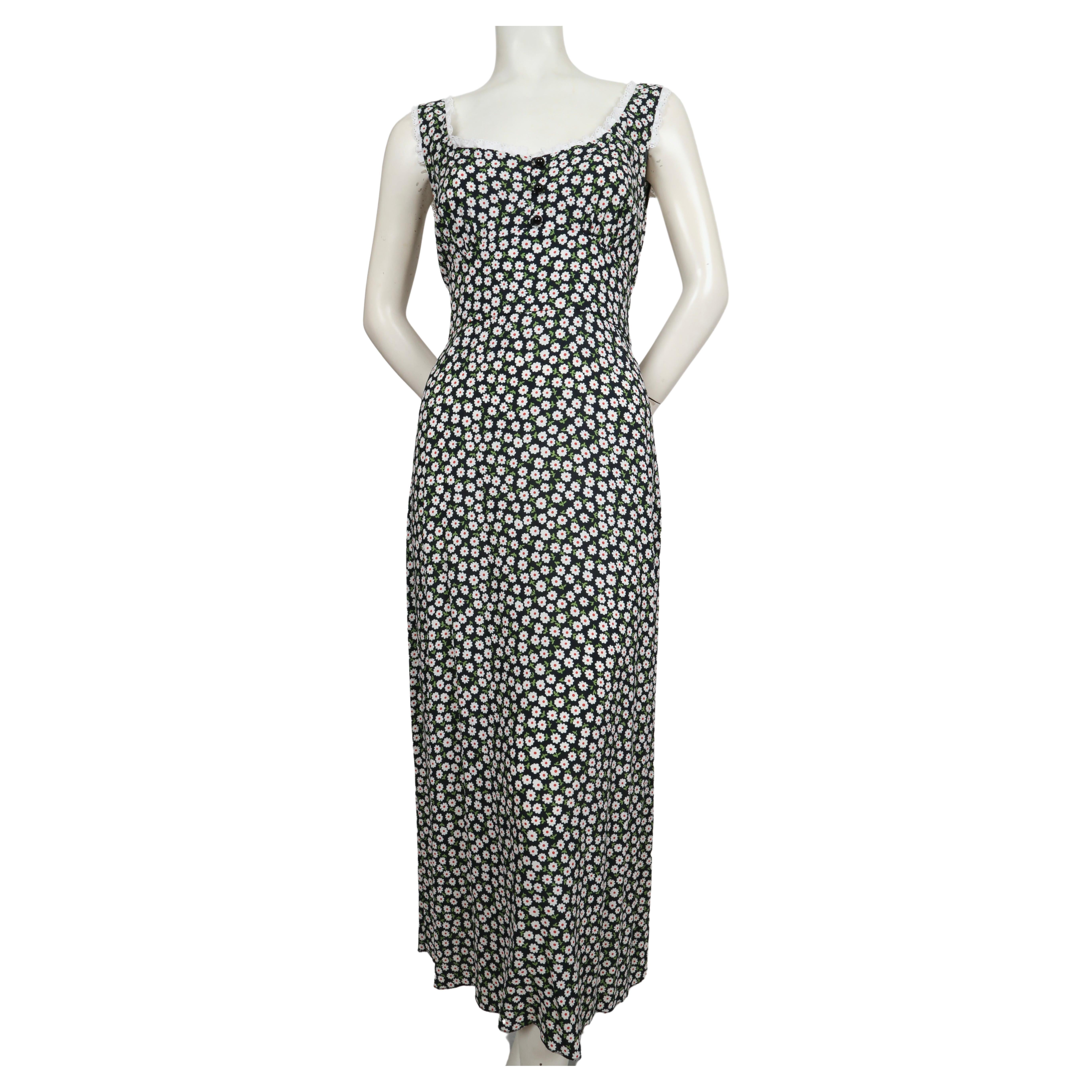 Floral printed viscose crepe dress with white Broderie Anglaise lace trim and button front designed by Muccia Prada for Miu Miu. Deepest navy blue background. Size 42 Approximate measurements: bust 36