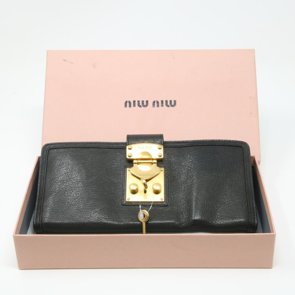 Miu Miu Goatskin Leather Lock and Key Flap Passport Case Wallet

This chic day to evening wallet is crafted of luxurious goatskin leather in black. MIU MIU Leather wallet, clutch. It will hold all your on-the-go necessities and more. It has three