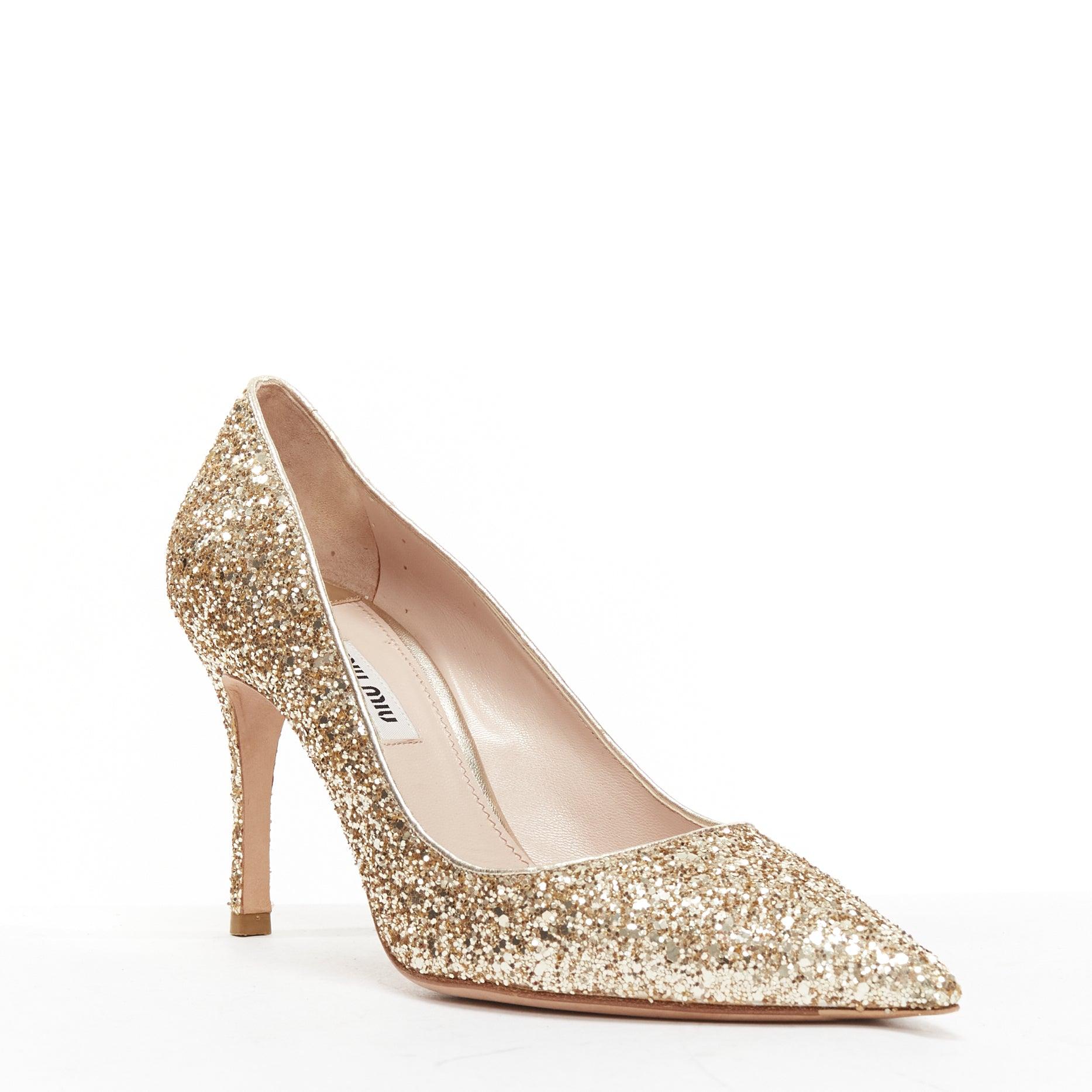 MIU MIU gold glitter pointed toe stiletto party pumps EU38
Reference: BSHW/A00146
Brand: Miu Miu
Designer: Miuccia Prada
Material: Leather
Color: Gold
Pattern: Solid
Closure: Slip On
Lining: Nude Leather
Extra Details: Stiletto heels.
Made in: