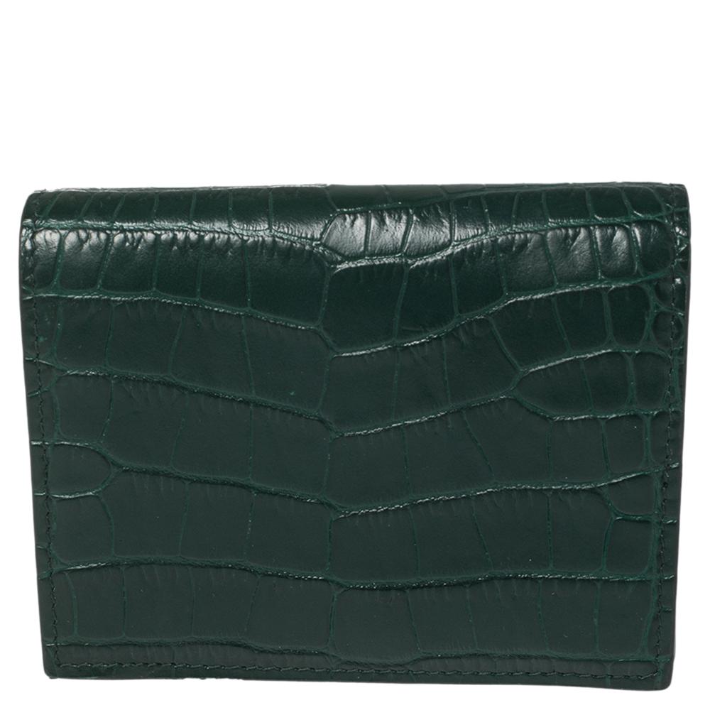 Store your daily essentials and put together a stylish look with this wallet from Miu Miu. Store your essentials effortlessly in this sturdy croc-embossed leather wallet. The impeccable design and green color of this wallet impart a suave touch.


