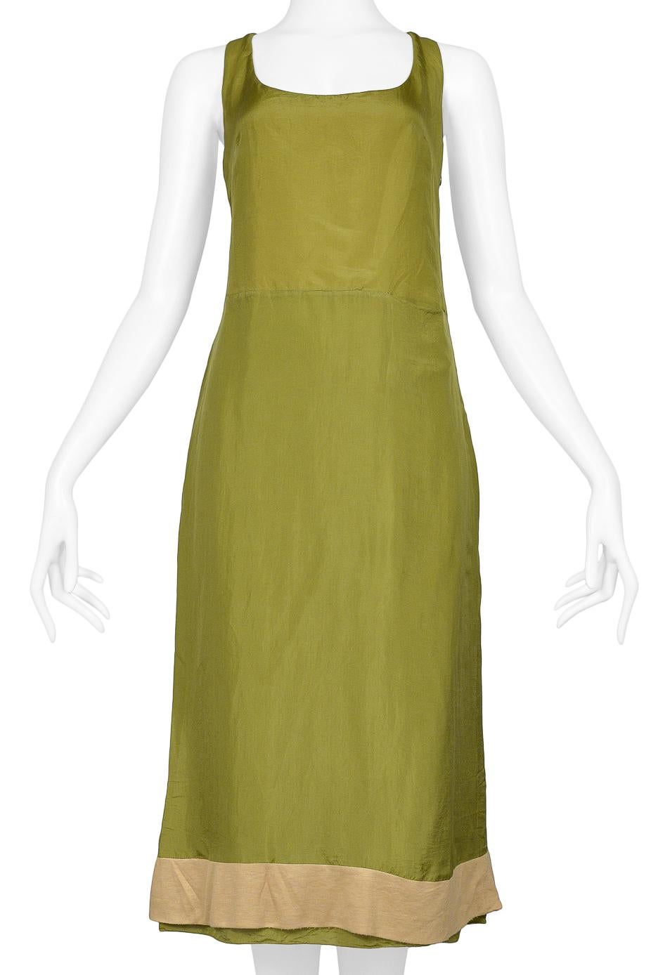 Resurrection Vintage is excited to offer a vintage Miu Miu olive green slip dress featuring a scoop neck, slightly high waistline, and contrasting nude tone band above the hem.  

Miu Miu
Size 42
Feels Like Silk
Very Good Vintage