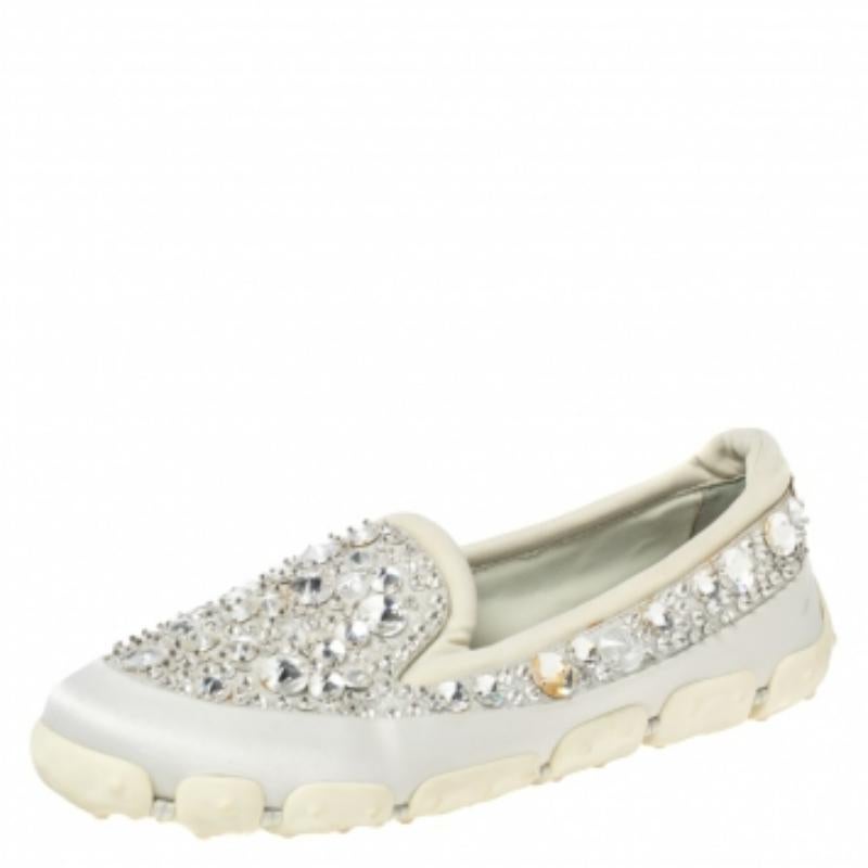 Beautifully crafted using fabric and satin, these Miu Miu slip-on sneakers are sure to keep you comfortably stylish. Featuring crystals, sturdy soles, and lightly padded insoles, these shoes will be a great addition to your closet.