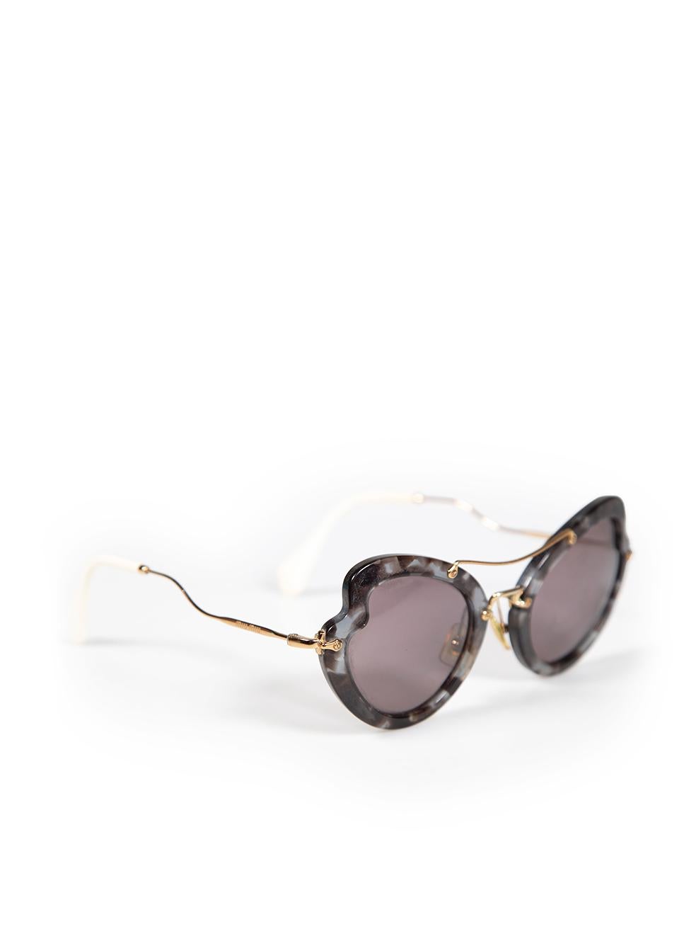 CONDITION is Good. Minor wear to sunglasses is evident. Light wear to the plastic arms, with discolouration to the ends. Some tarnishing to the plastic frames and light scratches to the lenses on this used Miu Miu designer resale item. This item