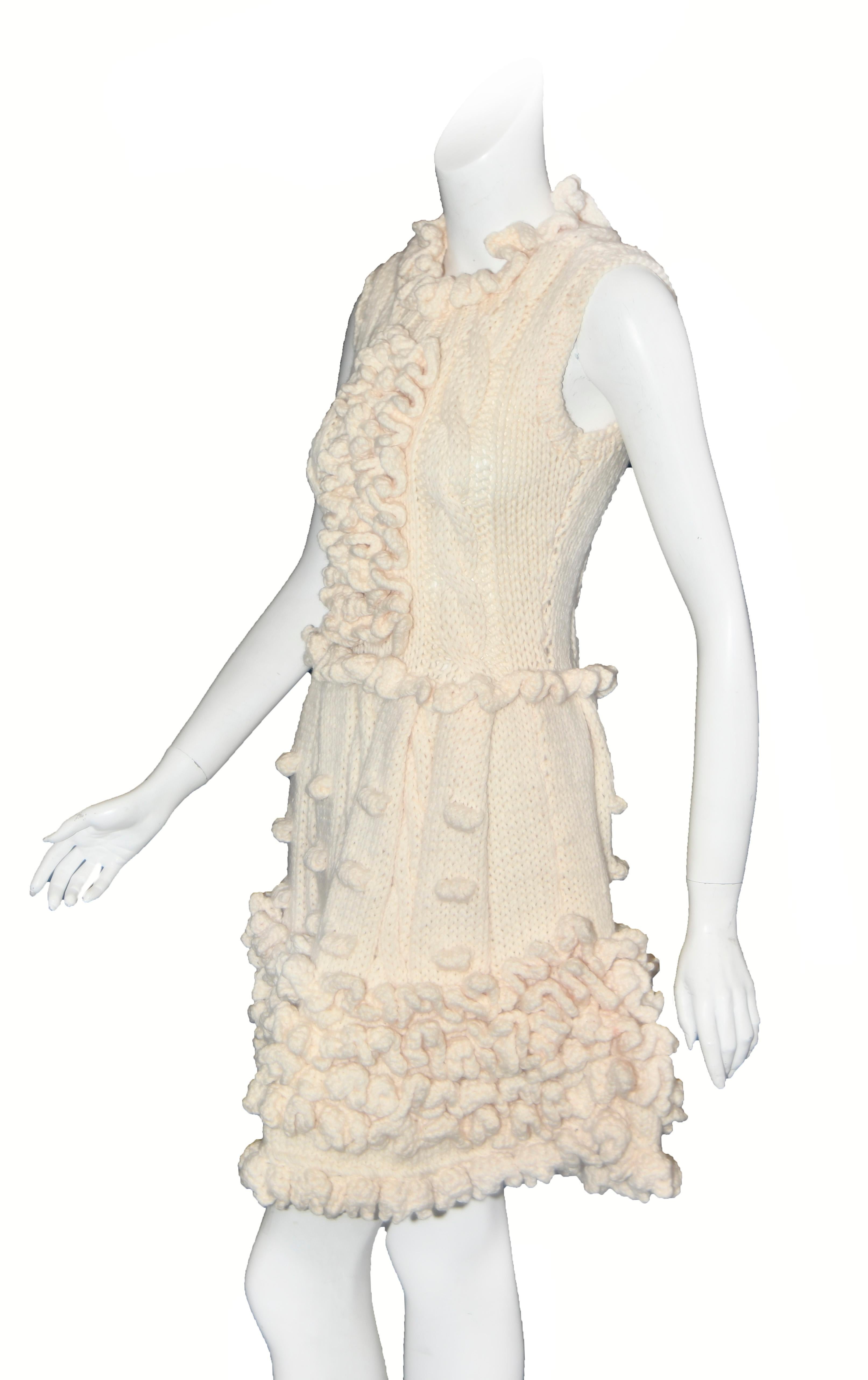 Miu Miu ivory handmade virgin wool crochet dress is a burst of ruffles everywhere!  This 2014 runway dress integrates the layers of ruffles beautifully, beginning with the crocheted ruffle collar then continuing with the ruffles down the front of