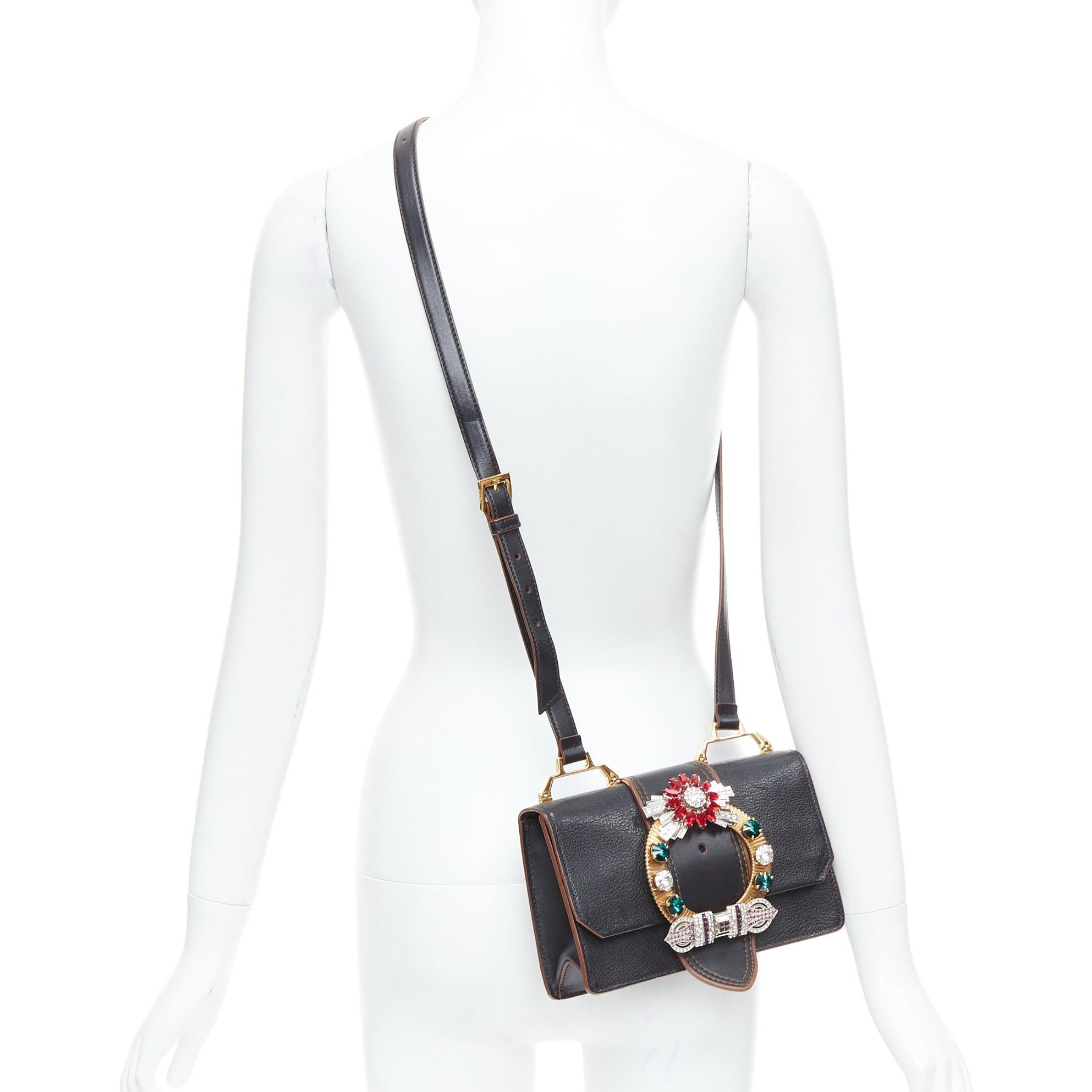 MIU MIU Lady black leather colorful rhinestone buckle flap crossbody bag
Reference: CELE/A00039
Brand: Miu Miu
Designer: Miuccia Prada
Model: Miu Lady
Material: Leather
Color: Black, Multicolour
Pattern: Solid
Closure: Magnet
Lining: Black