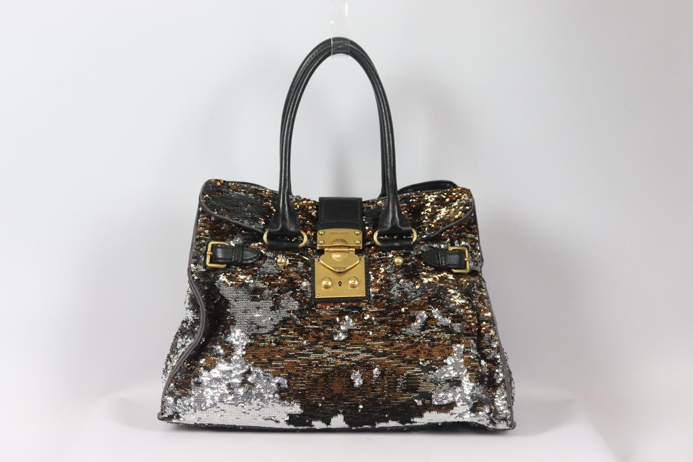 Miu Miu leather trimmed sequined satin tote bag. Silver, navy, brown and black. Push lock fastening at front. Does not come with dustbag or box. Height: 11.5 in. Width: 15.5 in. Depth:5.1 in. Handle Drop: 6.25 in. Good condition - Some signs of wear