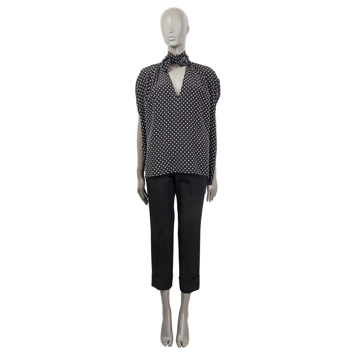 100% authentic Miu Miu sleeveless polka dot blouse in black and white silk (100%). Features a pussy bow, a v-neck and an oversized fit. Unlined. Has been worn and is in excellent condition.

Measurements
Tag Size	40
Size	S
Shoulder Width	54cm