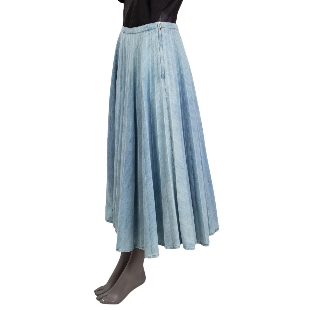 100% authentic Miu Miu pleated denim skirt in washed out light blue cotton (100%). Features a distressed hemline and a black 'Miu Miu' patch on the back. Opens with a concealed zipper and a button on the side. Unlined. Has been worn and is in