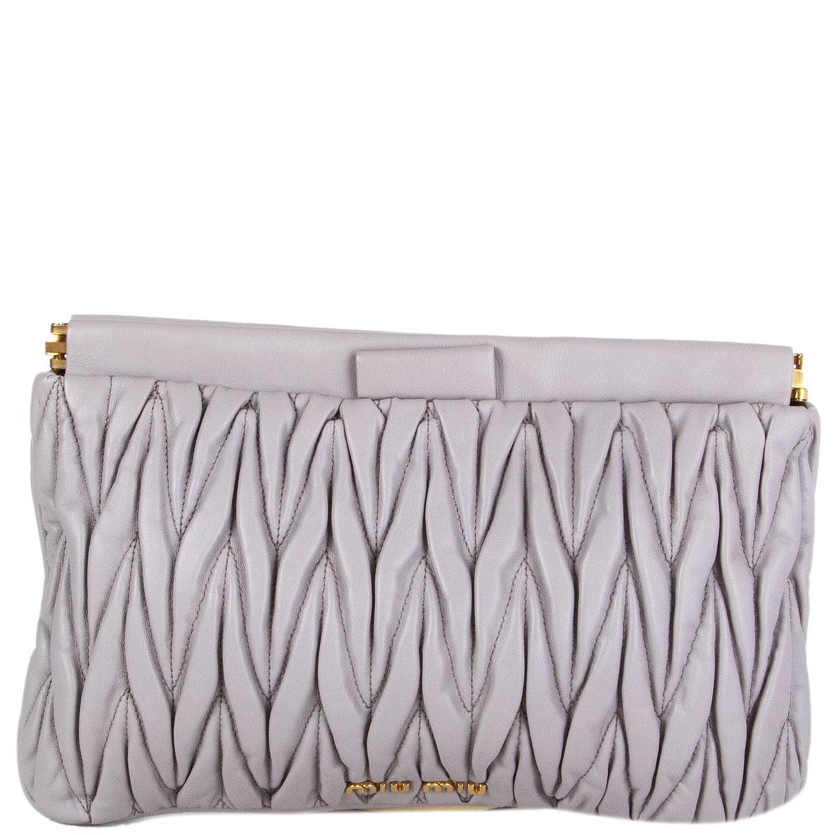 100% authentic Miu Miu Matelassé clutch in dove grey smootch calfskin featuring gold-tone hardware. Lined in black canvas with one open pocket against the back. Has been carried and is in excellent condition. Comes with dust bag.