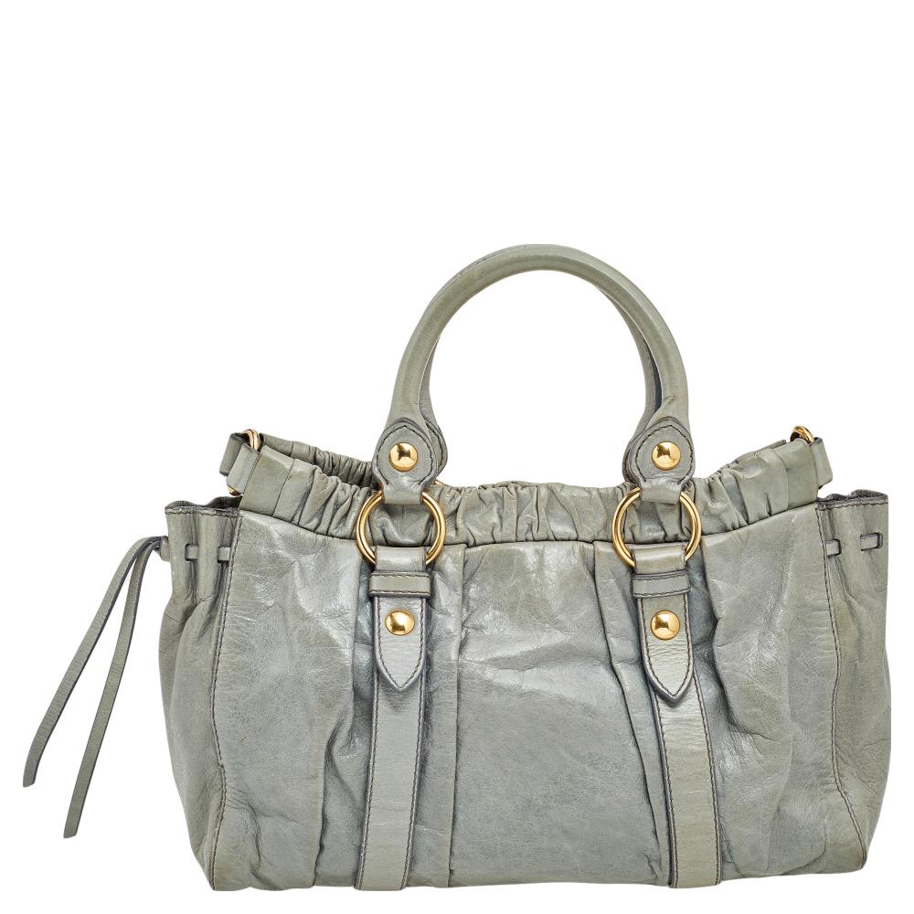 Miu Miu brings you this lovely gathered tote that has been crafted from leather. It has a well-sized fabric interior and the bag is complete with two top handles and a shoulder strap. Stylish and ideal for daily use, this bag is a worthy buy.

