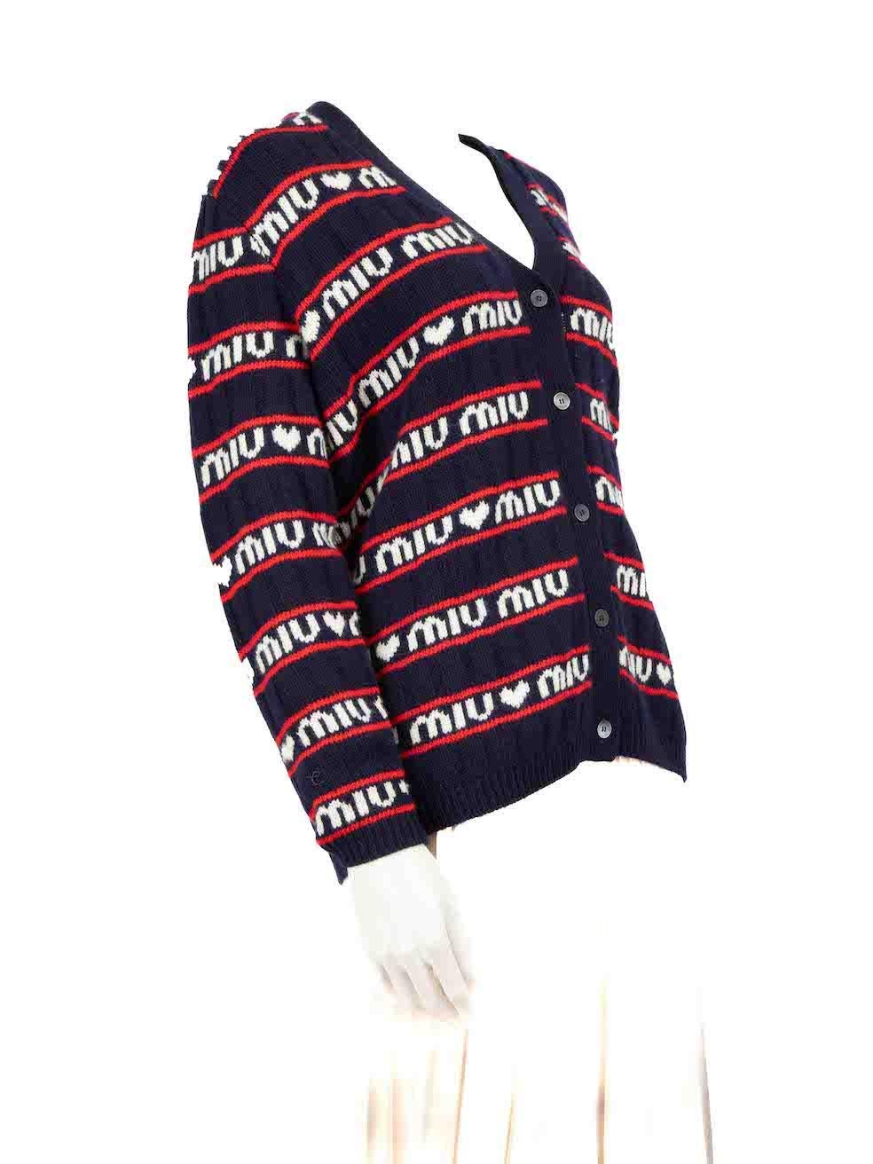 CONDITION is Very good. Minimal wear to the cardigan is evident. Overall pilling especially to the front and sleeves of the cardigan. Pull to weave on the back left side and small scratches to the buttons on this used Miu Miu designer resale item.
