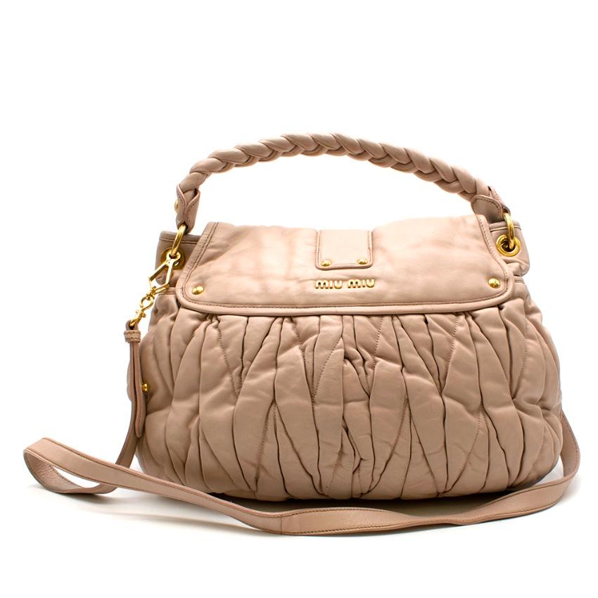 Miu Miu Matelasse Beige Leather Tote Bag

- Gold tone hardware 
- flap opening to a fabric lined interior
- Braided top handle
- Detachable shoulder strap 
- Dual pockets on the front
- Quilted front design 
- embossed branding front and back 
-
