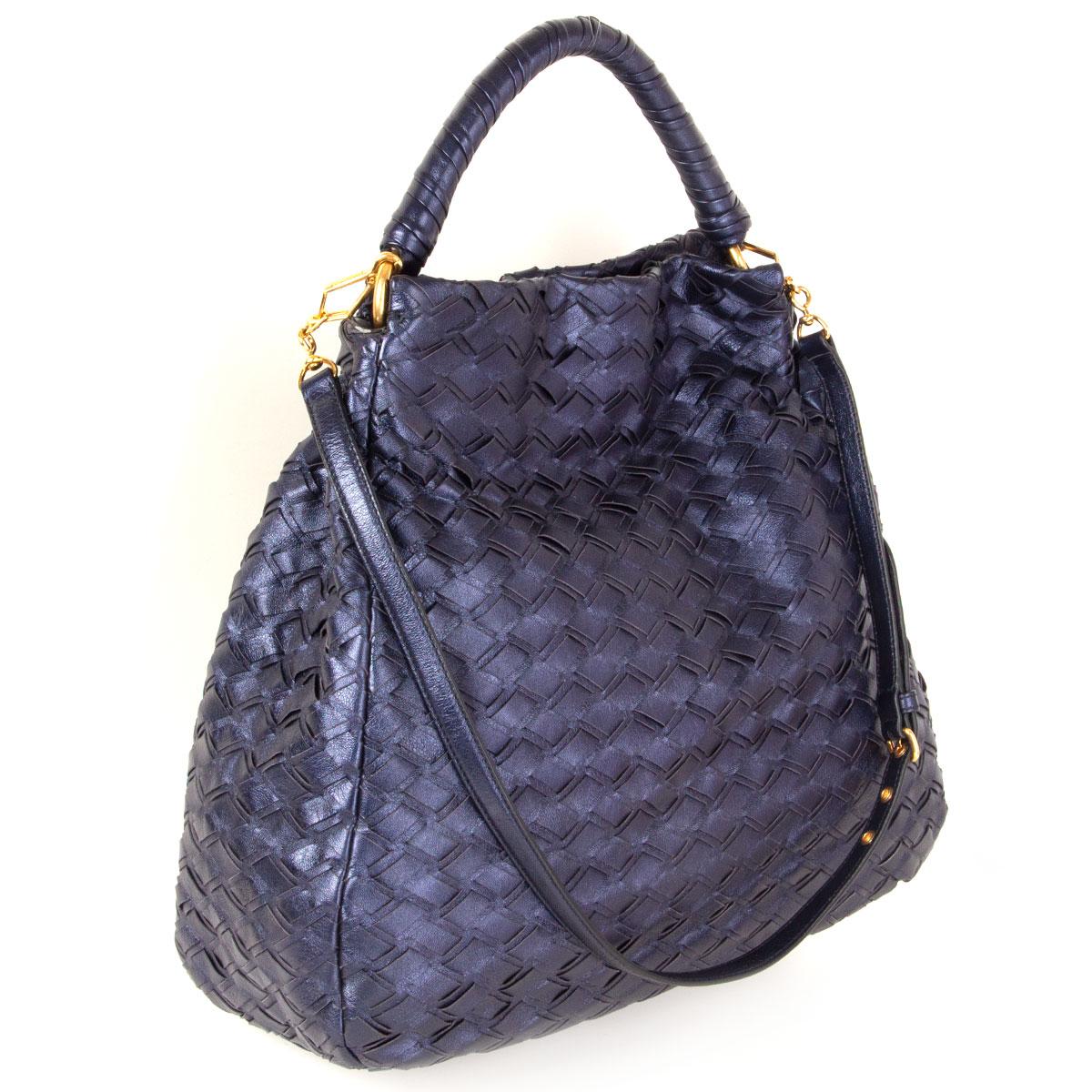 100% authentic Miu Miu woven hobo bag in metallic navy blue lambskin featuring gold-tone hardware. Comes with a detachable and adjustable shoulder-strap. Opens with two push-buttons on top and is lined in deep purple satin with one zipper pocket