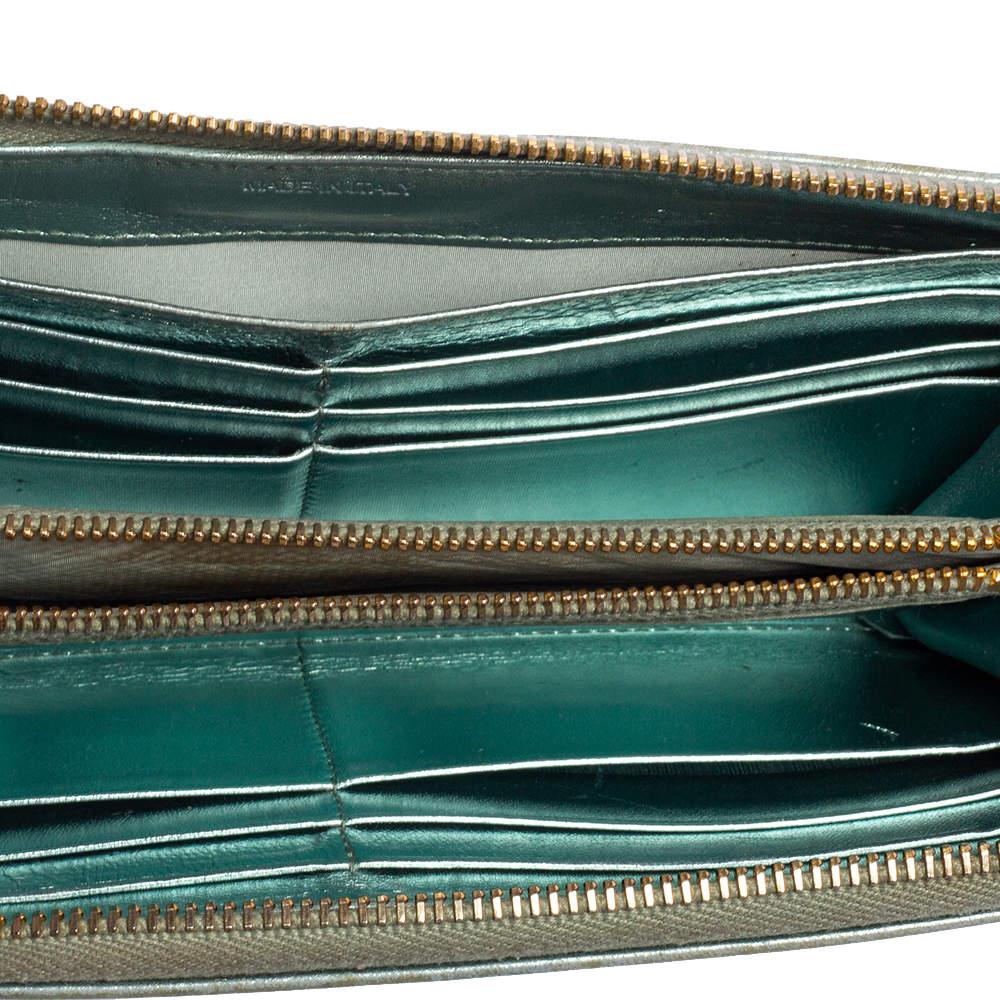 Carry your essentials effortlessly with this Miu Miu leather wallet. Displaying a metallic blue exterior crafted from leather the zip around closure secures your belongings well. In addition to its practical use you can style this wallet as a