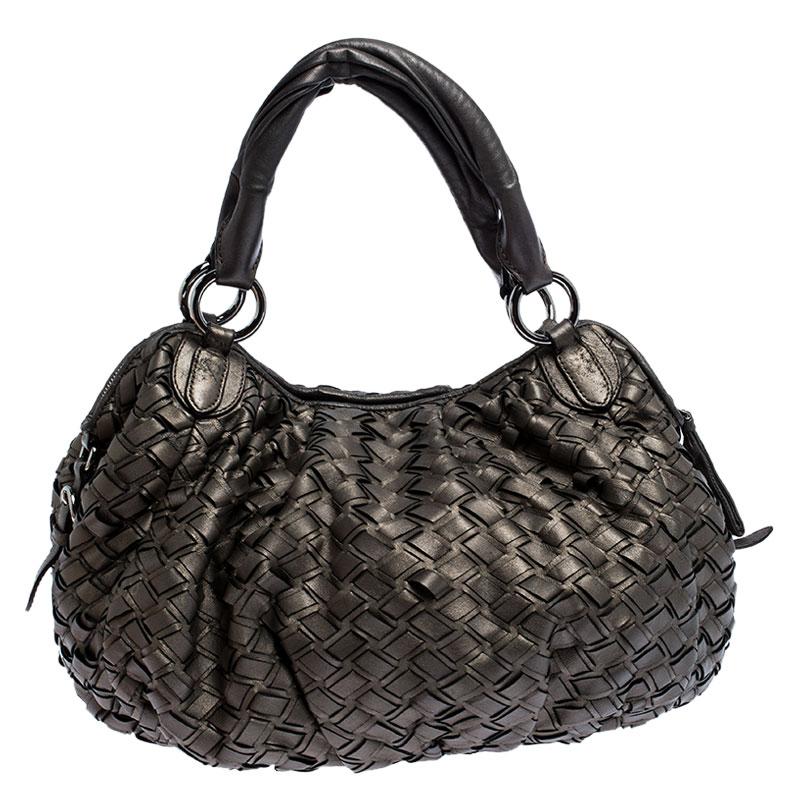 This smart and practical hobo from the house of Miu Miu is designed in a metallic grey woven leather body and features two handles. Secured with a top zipper, this bag has a spacious satin interior and protective metal feet.

Includes: Original