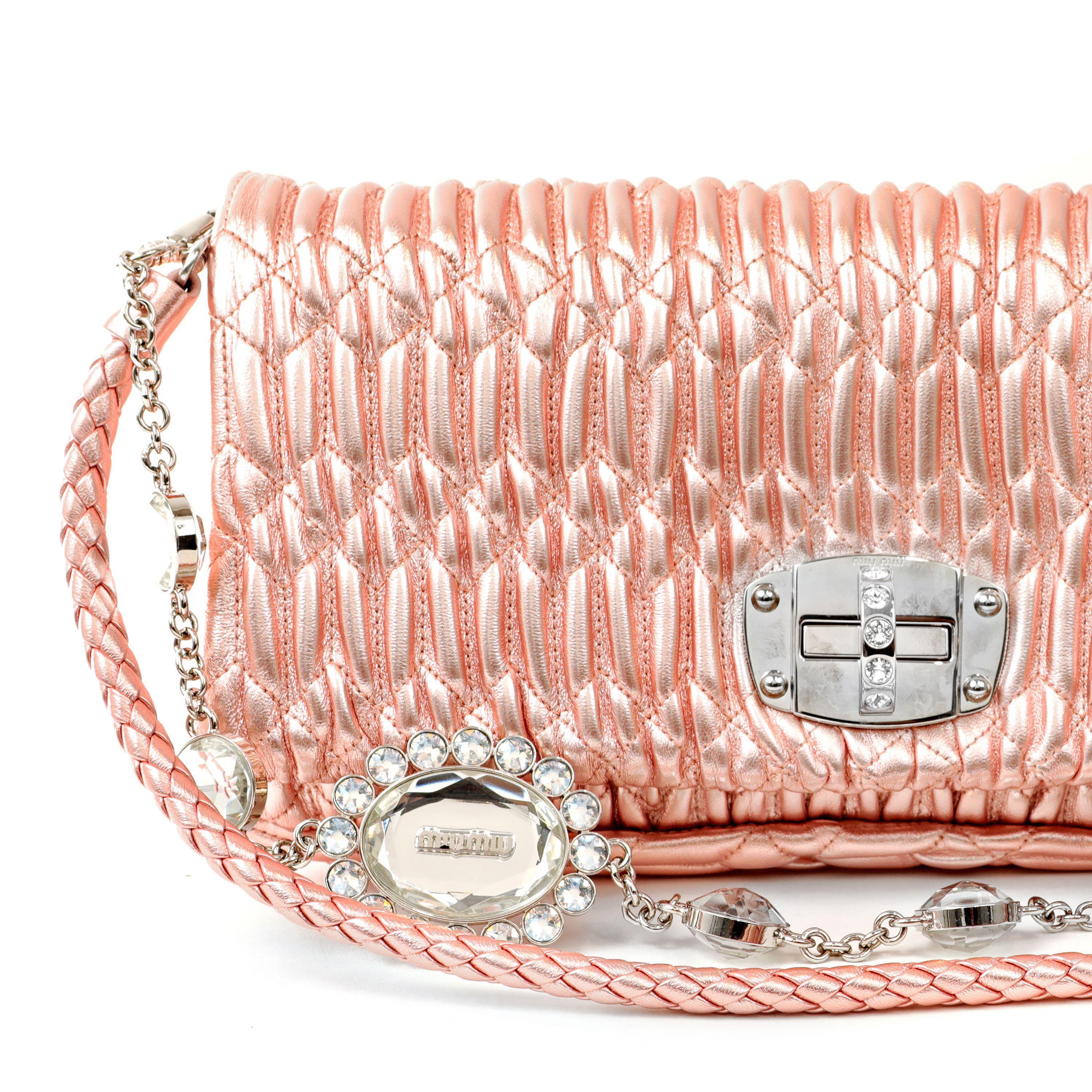 This authentic Miu Miu Metallic Pink Crystal Cloquè Small Bag is in pristine condition.  The iconic design features shimmery pink raised quilted Nappa leather with silver and crystal turn lock closure.  May be carried by the detachable leather strap