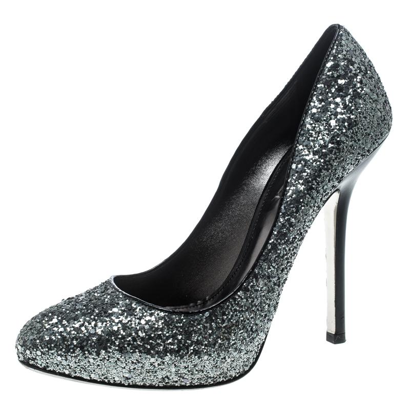 Shimmering, scintillating and oh so lovely, these pumps from Miu Miu are love at first sight! These metallic silver pumps are crafted from coarse glitter and feature almond toes, leather lined insoles and 13 cm stiletto heels. Pair them with your