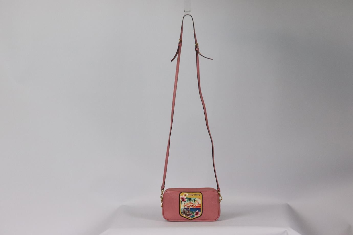 Miu Miu mini badge appliquéd textured leather shoulder bag. Pink. Zip fastening at top. Does not come with dustbag or box. Height: 4 in. Width: 7 in. Depth: 1.5 in. Strap Drop: 21.5 in. Very good condition - Few light marks to interior fabric; see