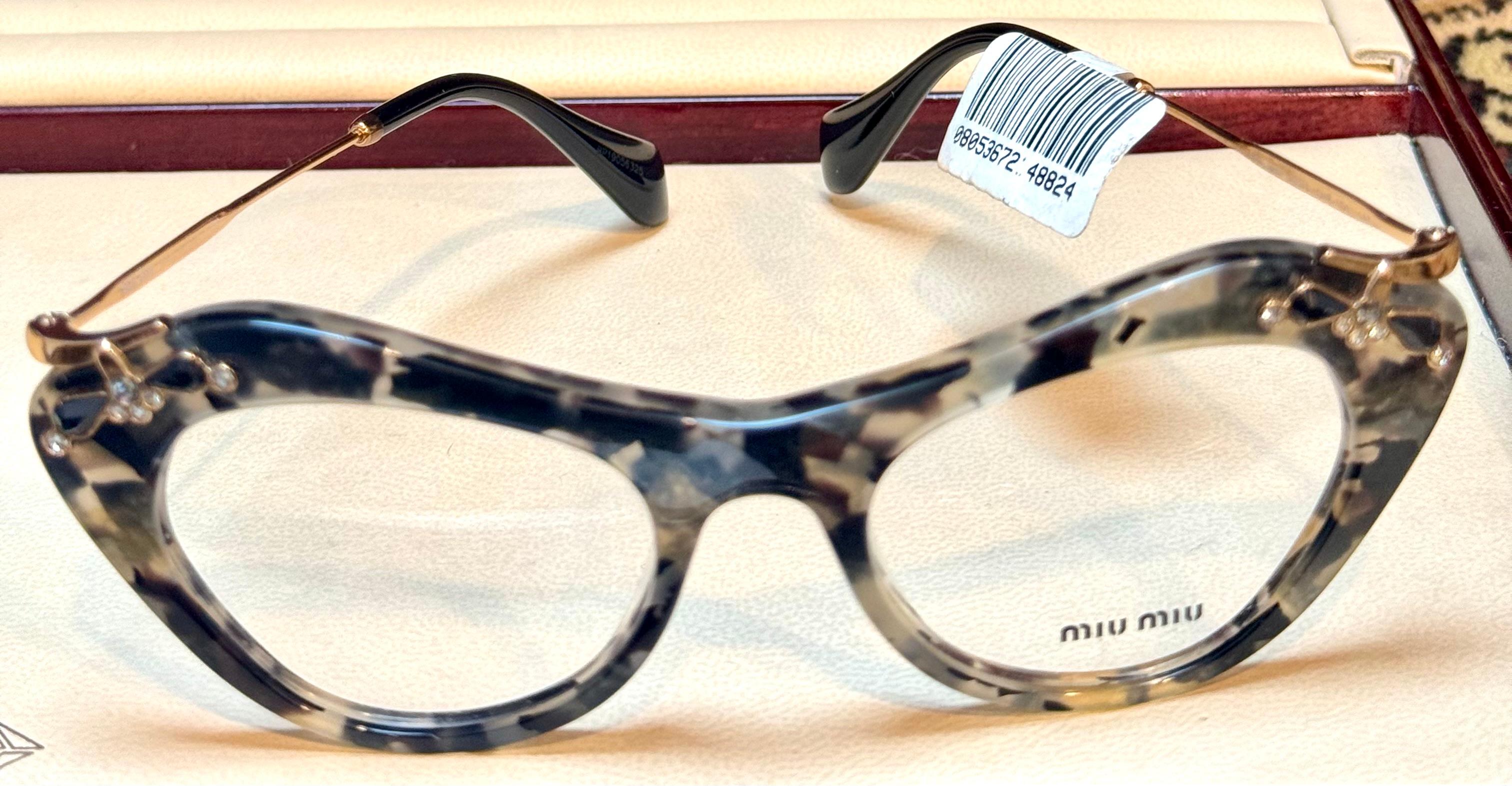 
Miu Miu MU 09MV DHE1O1 Grey/Black  Optical Eyeglasses 49/19/140, Ornated with black and white stones
Gender: Unisex

Directed to younger generations, Miu Miu is tailored for hip, spirited individuals that aren’t afraid to stand out. A free-spirited