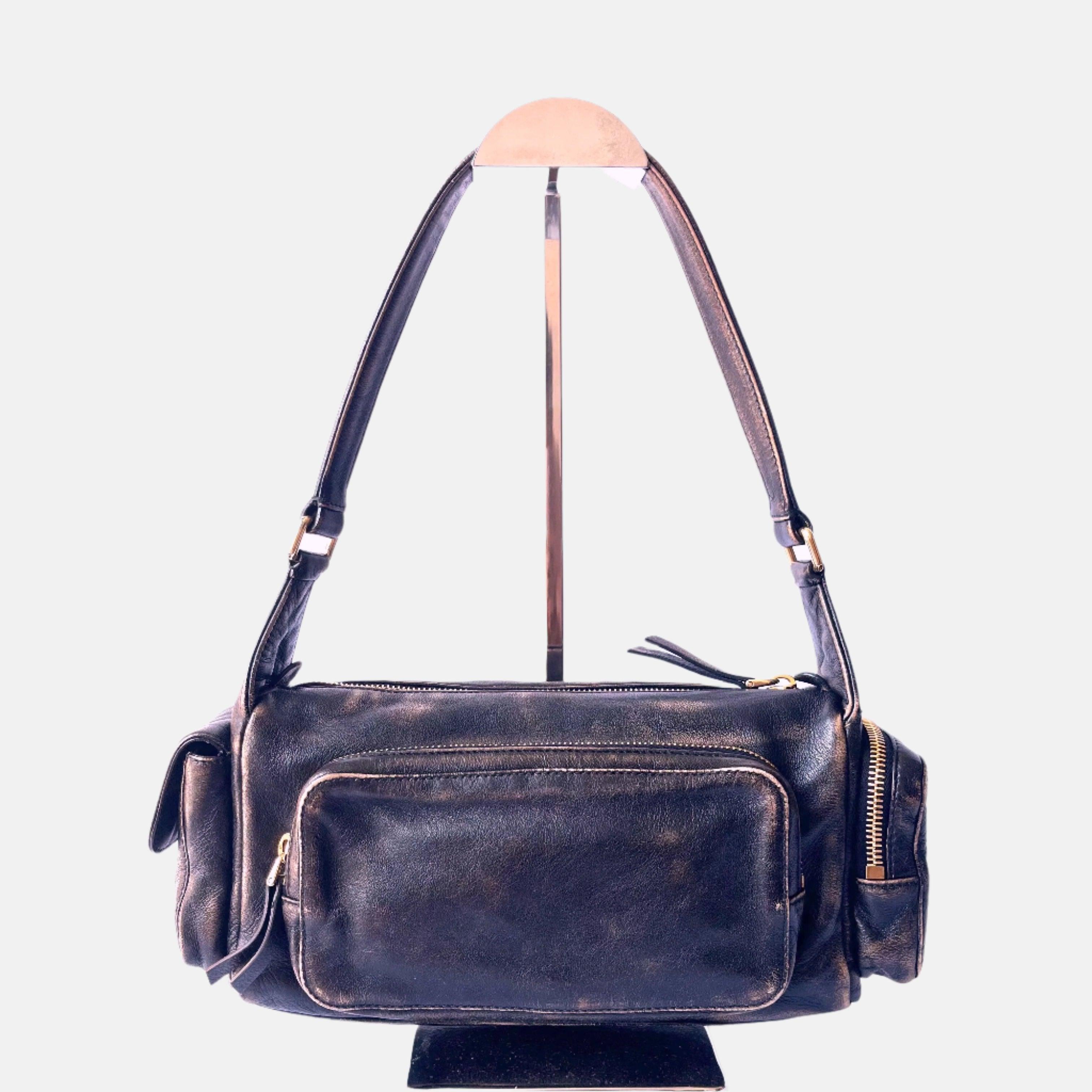 Miu Miu Multi Pocket Nappa leather bag Sand/Coffee
  These are professional photos of the actual bag offered by Luxbags.
  
  
  
  The aesthetic of this leather bag is both refined and captivating, with multiple pockets that draw inspiration from