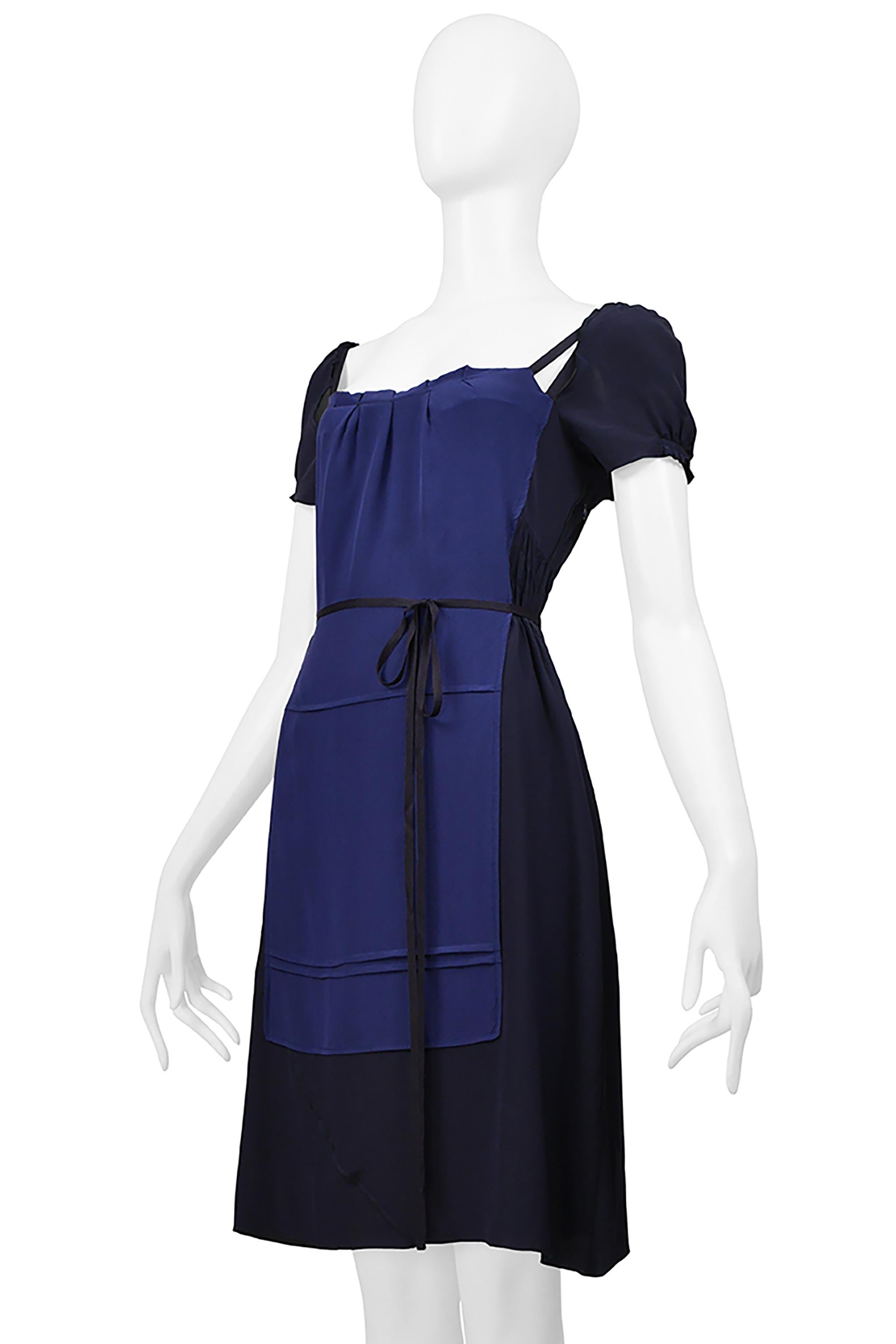 Resurrection Vintage is pleased to offer a vintage Miu Miu two-tone navy and blue silk apron dress featuring an apron panel with ties, bodice cutouts, delicate pleating, a size zipper closure, and knee length. 
* Miu Miu
* Size 44
* 100% Silk 
*