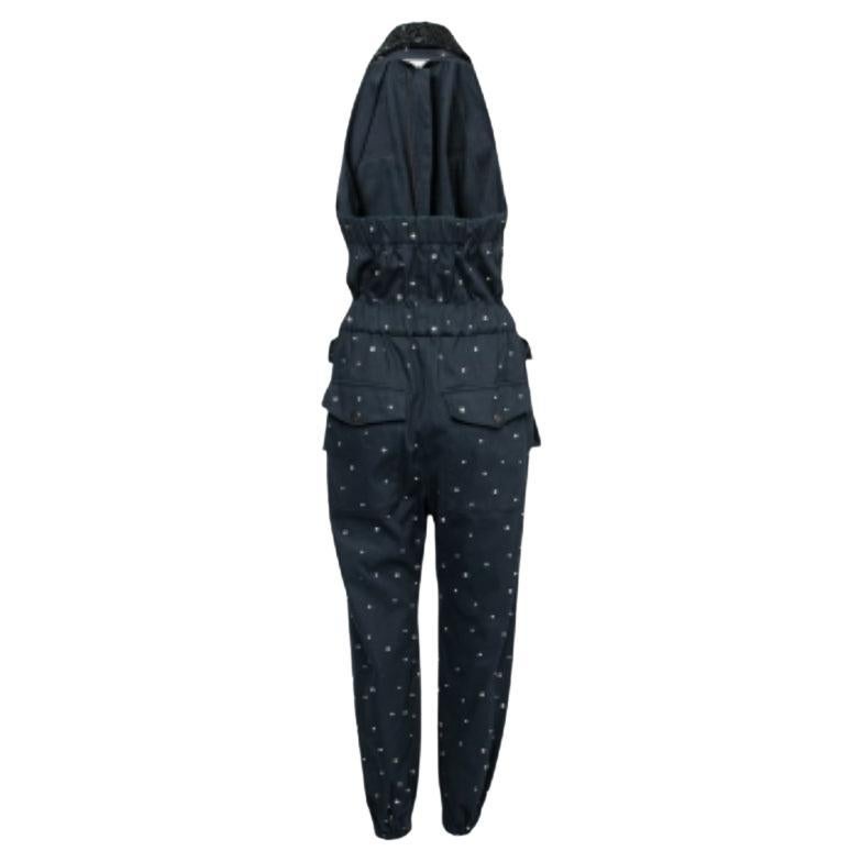 This Miu Miu jumpsuit will be an elegant addition to your closet. Crafted skillfully from cotton and featuring embellishments and bead embroidery, the halter neck creation has a navy blue shade that will match well with minimal accessories. It is