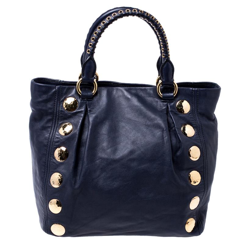 This gorgeous satchel is designed with a spacious silhouette and accentuated with a covetable navy blue shade all over the exterior along with gold-tone stud detailing. Crafted from durable leather, this creation is lined with satin and has a