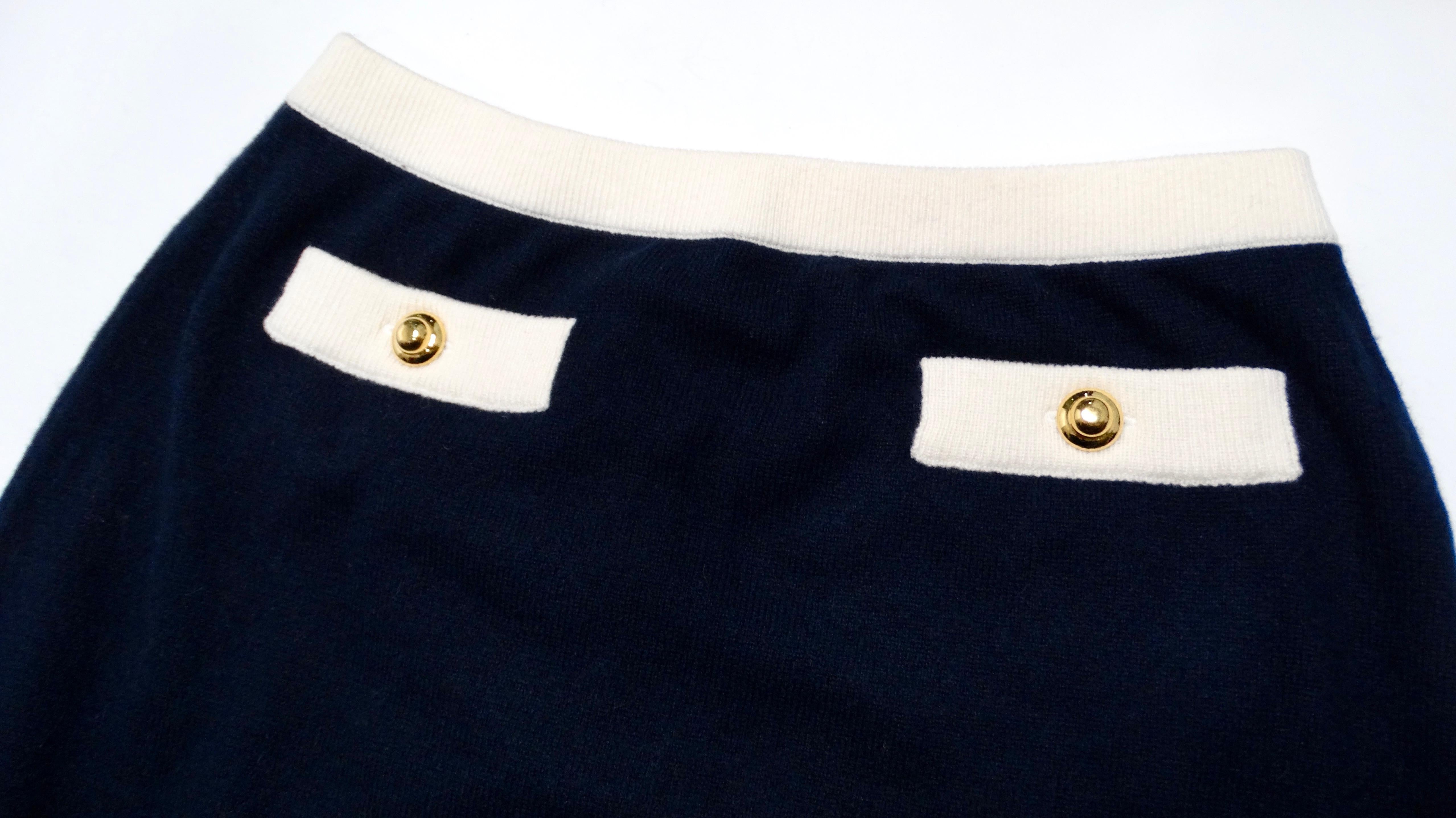Elevate your wardrobe with the luxurious Miu Miu Navy Blue & White Cashmere Mini Skirt, a perfect blend of elegance and comfort. Crafted from 100% cashmere, this piece features gold-tone button accents on the front, mimicking faux pockets that add a