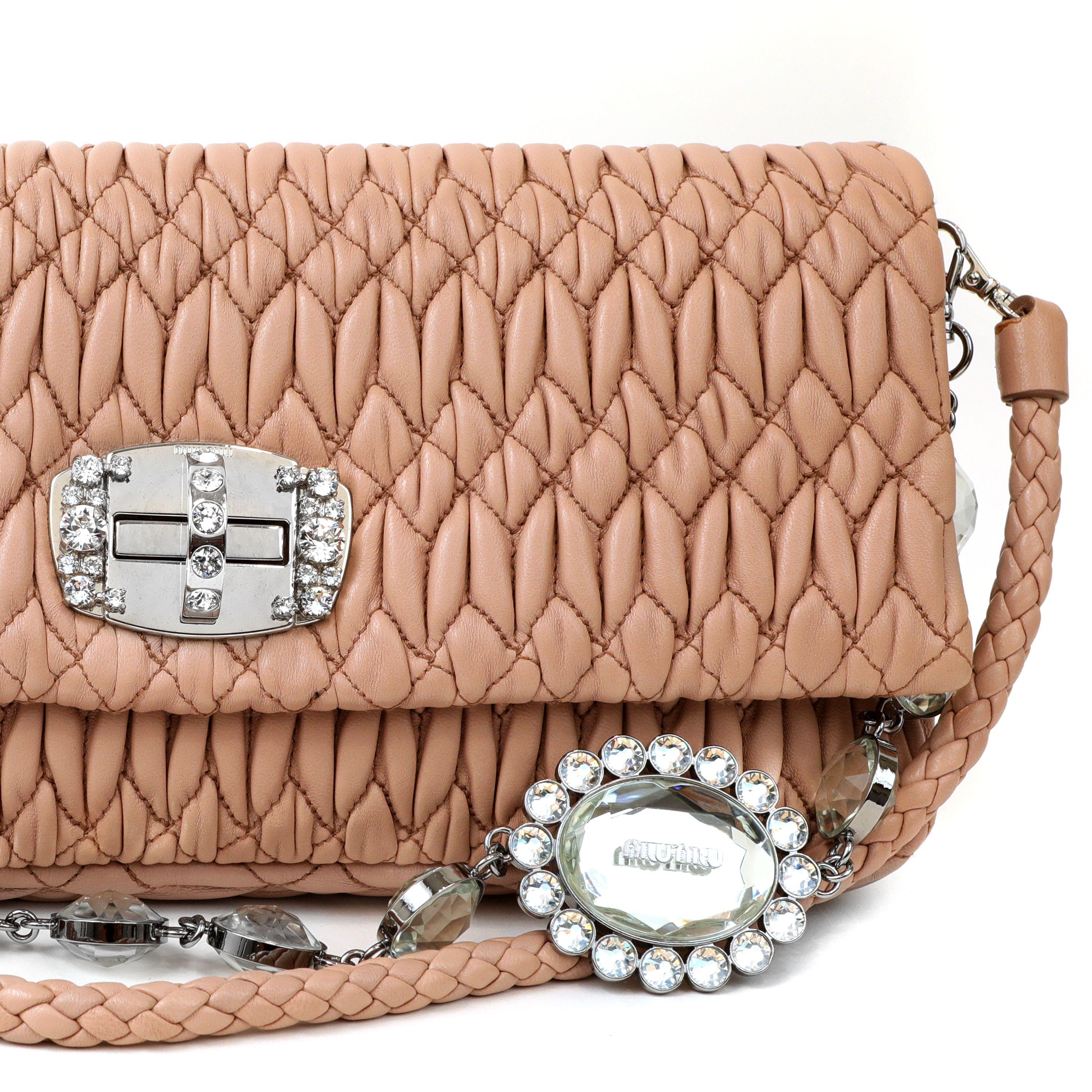 This authentic Miu Miu Nude Crystal Cloquè Small Bag is in pristine condition.  The iconic design features nude quilted Nappa leather and a crystal turn lock closure.  May be carried by the detachable leather strap or the decorative crystal strap.